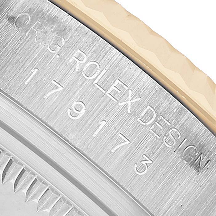 The image shows a close-up of the case side with engraving details on the Rolex Datejust 179173 Women's Steel and Gold (two tone) Champagne Dial watch.
