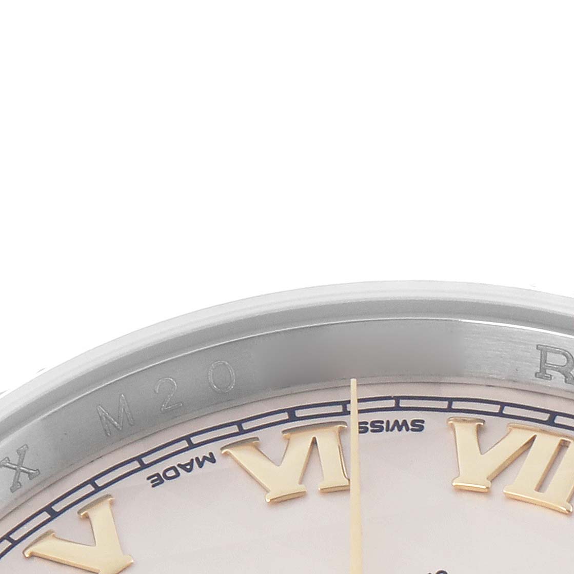 The image shows the edge of a Rolex Datejust model 116233 watch, focusing on Roman numerals and part of the bezel from an angled top view.