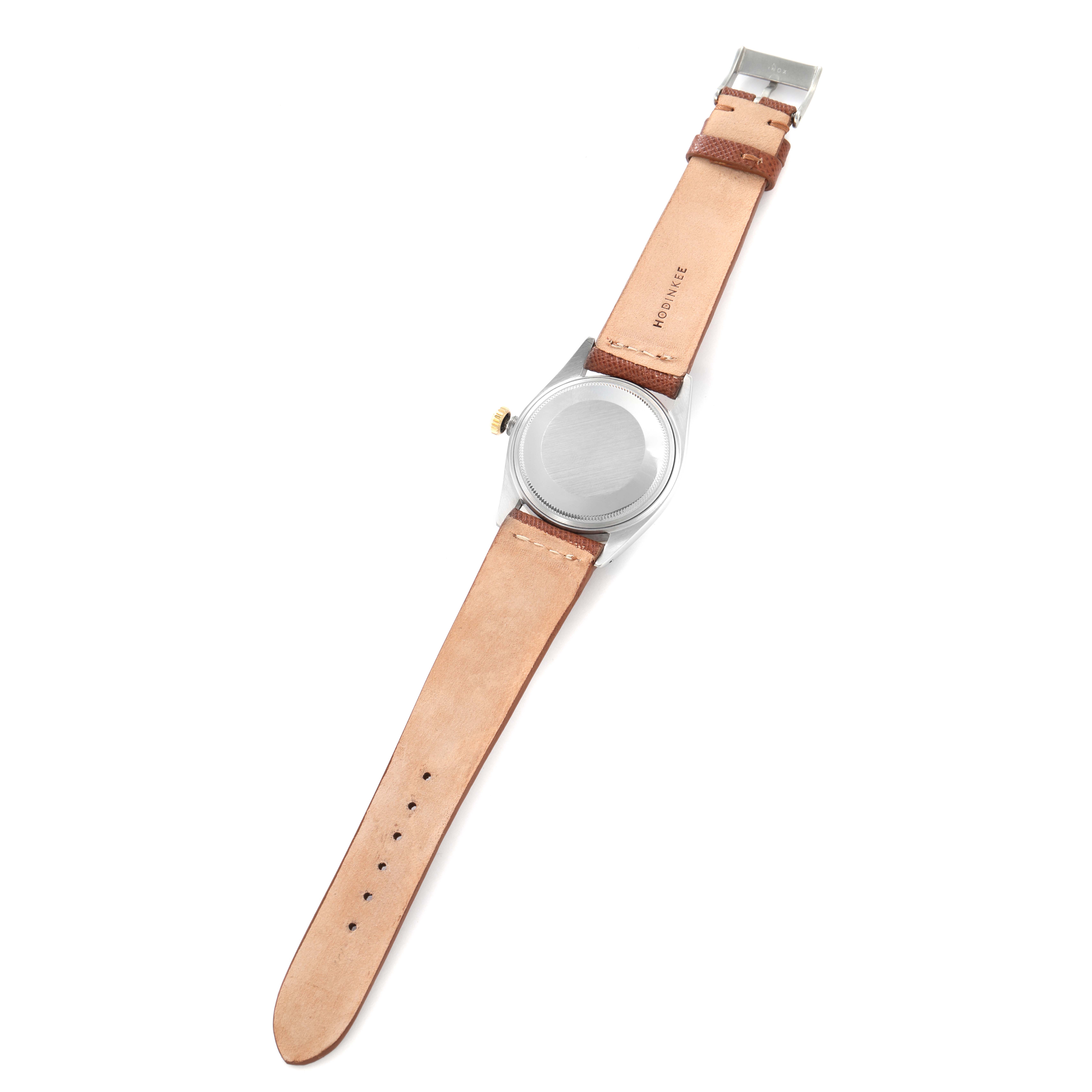 The image shows the back view of a Rolex Datejust model 1601 men
s watch, emphasizing the case back and leather straps.