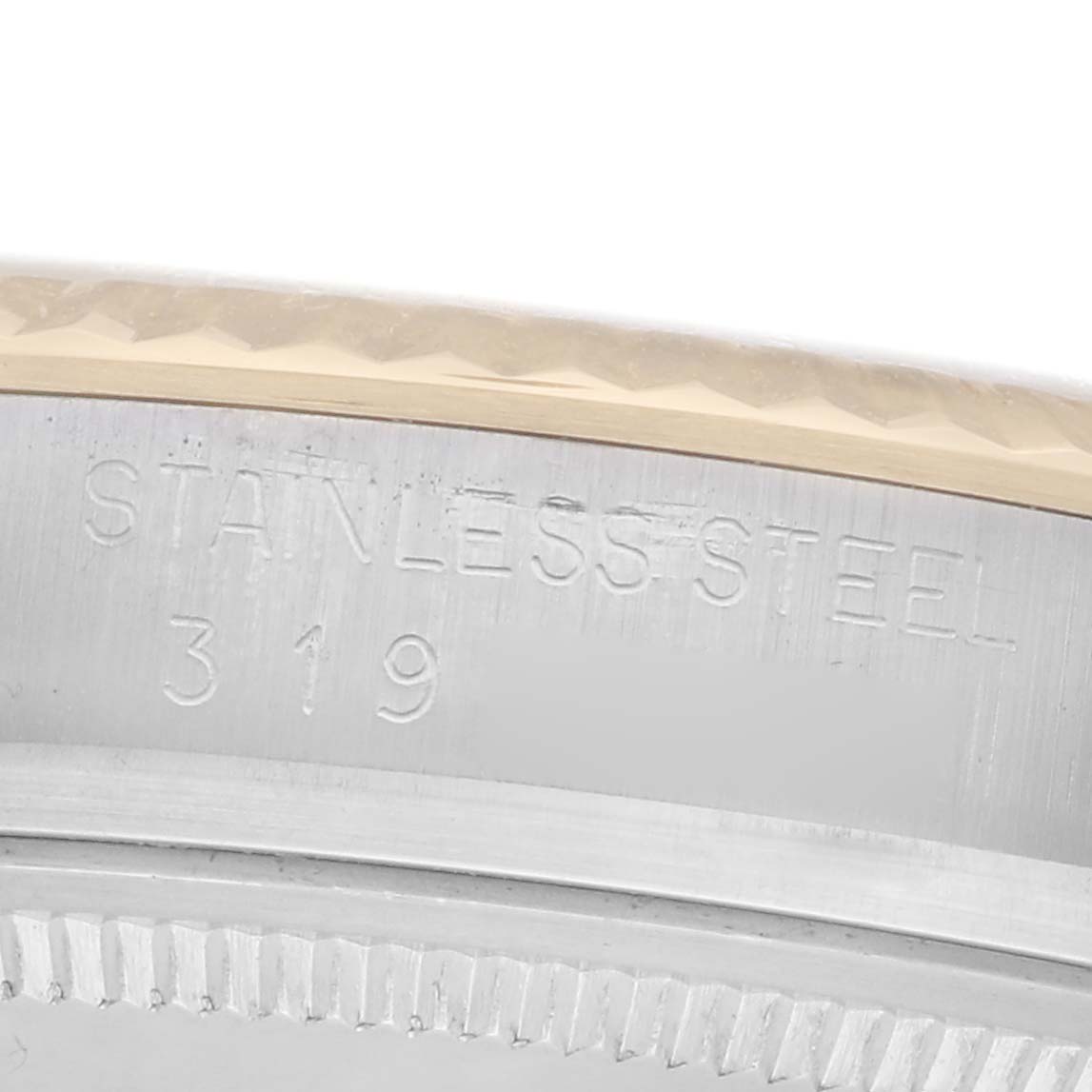The image shows a close-up of the side of a Rolex Datejust model 1601, focusing on the case edge and "STAINLESS STEEL" engraving.