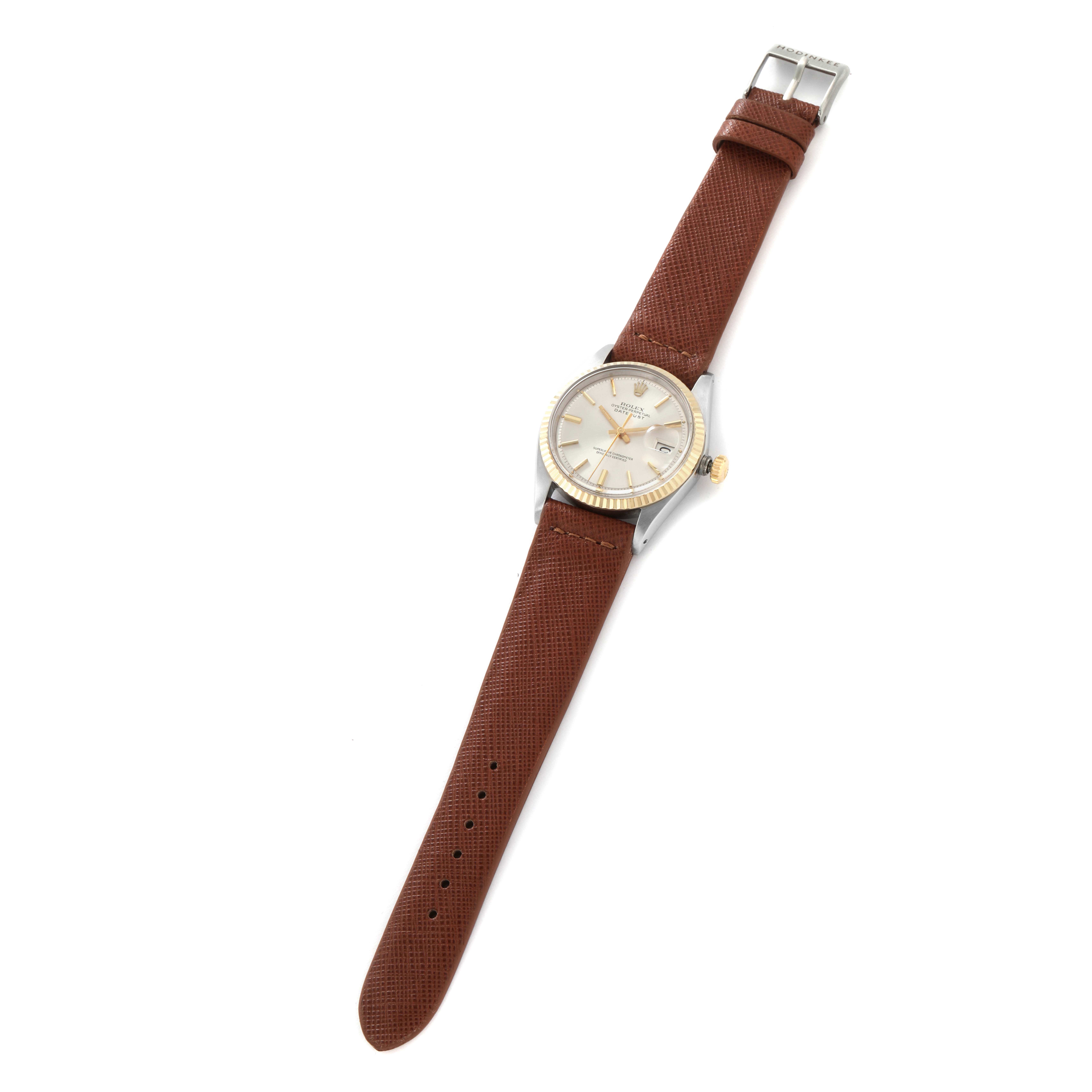 The Rolex Datejust 1601 men
s watch is shown from a top-down angle, displaying the entire watch with a brown leather strap and a clear view of the dial and bezel.