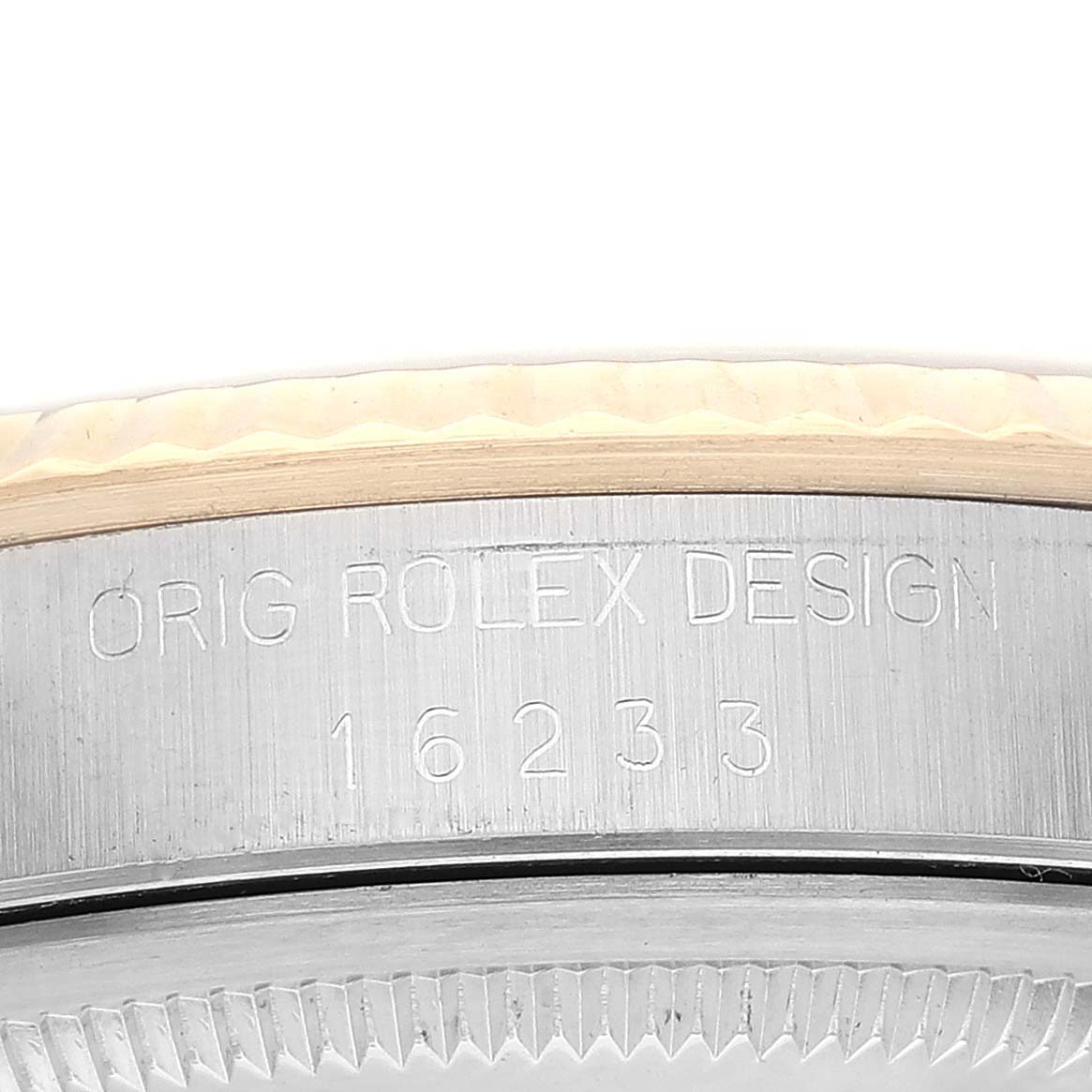 This image shows a close-up of the side of a Rolex Datejust 16233 Men's Steel and Gold (two tone) Silver Dial 16233 Men's Steel and Gold (two tone) Silver Dial watch, featuring engraved text and the fluted bezel edge.