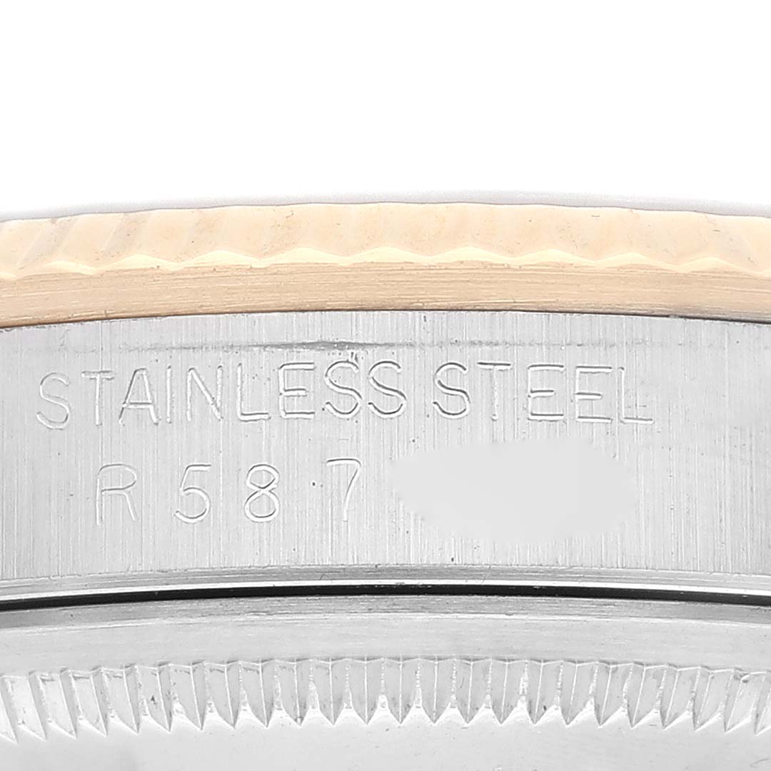 Close-up of the side and partial bezel of a Rolex Datejust 16233 Men's Steel and Gold (two tone) Silver Dial 16233 Men's Steel and Gold (two tone) Silver Dial watch, showing the stainless steel engraving.