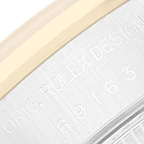 This close-up image shows a partial bezel and engraved casing of a Rolex Datejust 69163 Women's Steel and Gold (two tone) Grey Dial 69163 Women's Steel and Gold (two tone) Grey Dial watch.