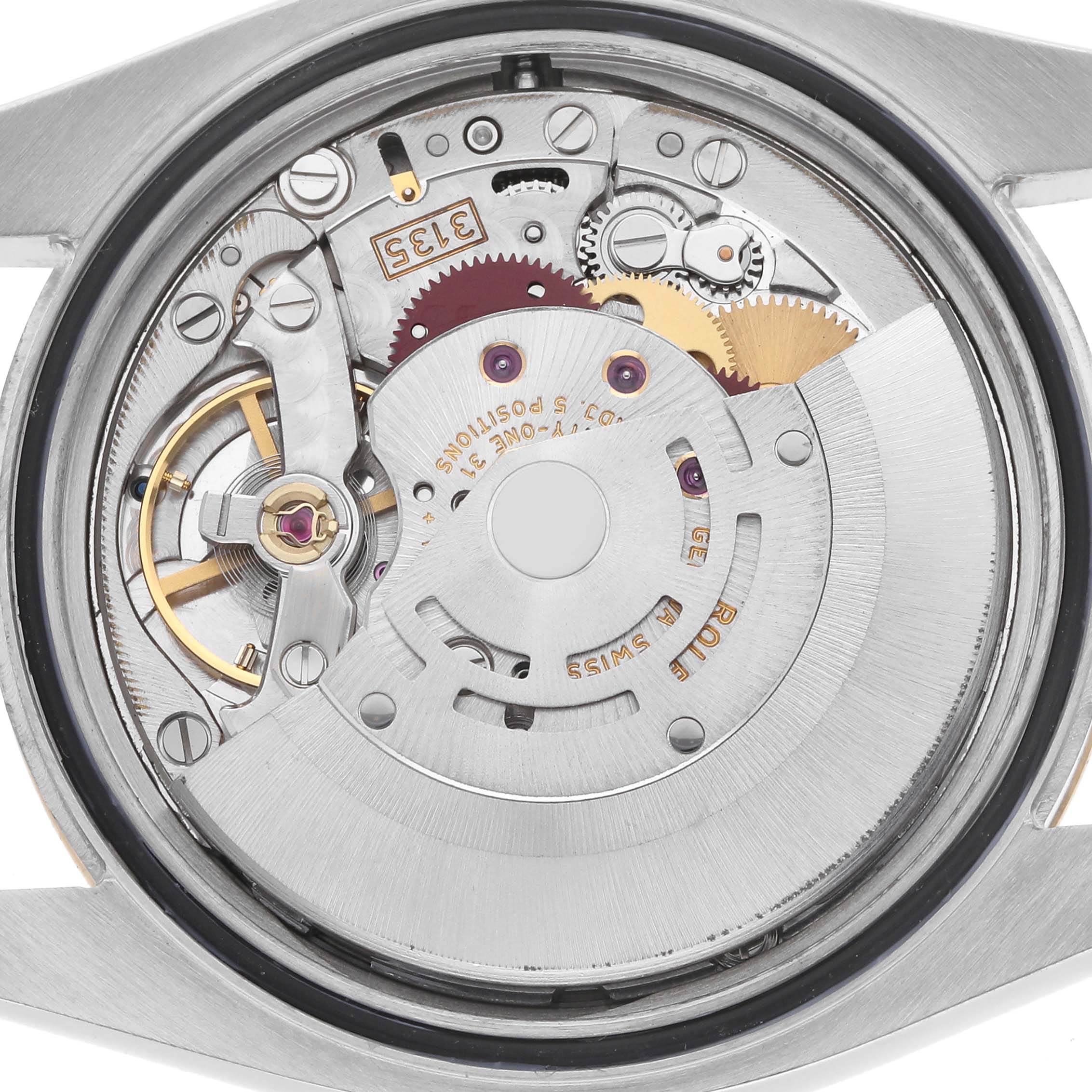 The image shows the movement mechanism of the Rolex Datejust model 116233, viewed from the back with various gears, rotor, and components visible.