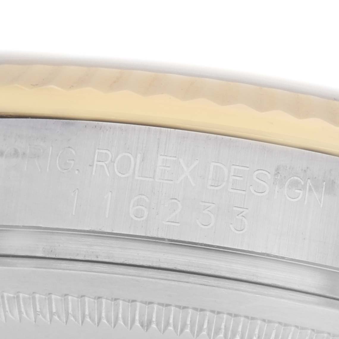 The image shows a close-up of the side edge of a Rolex Datejust model 116233, highlighting engraved text on the case side.