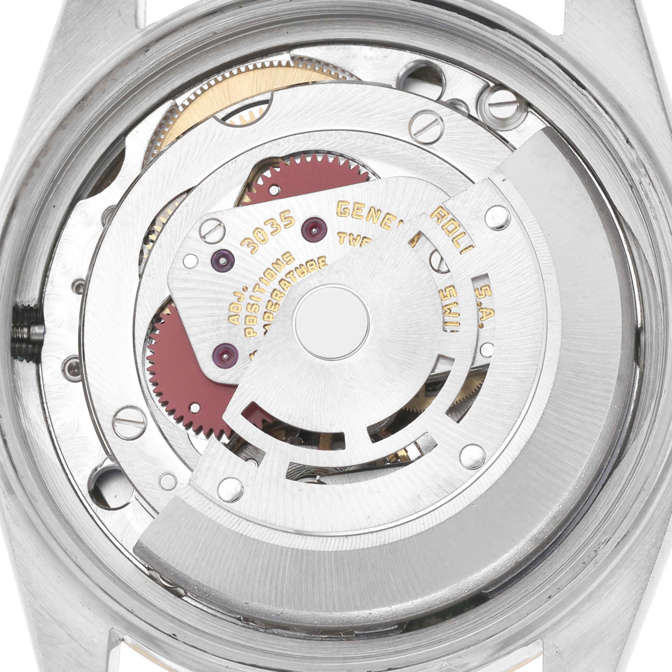 The image shows the movement of the Rolex Datejust model number 16013 from a top-down angle, highlighting gears and the rotor mechanism.