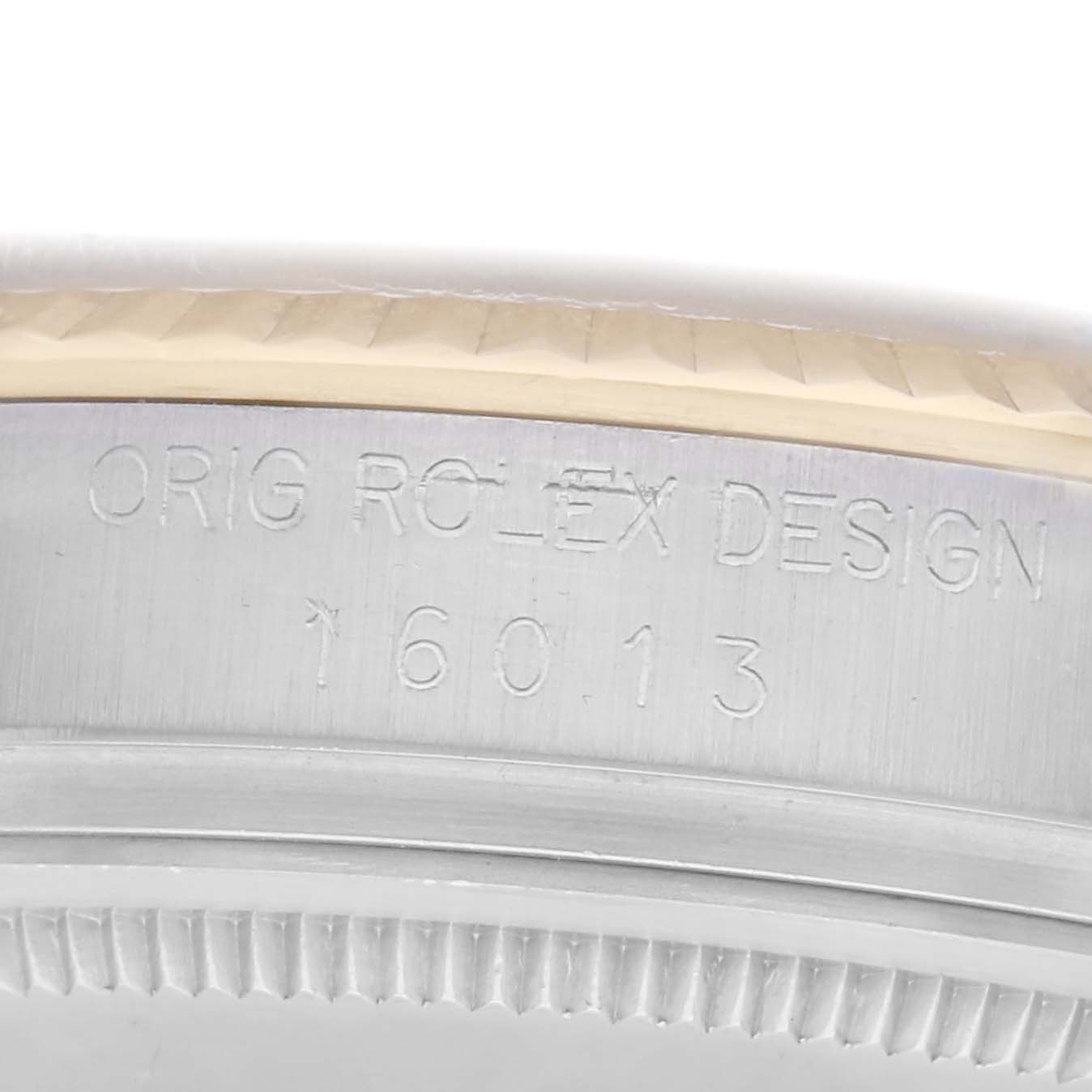 The image shows a close-up of the side of a Rolex Datejust, model number 16013, highlighting the engraved text on its bezel.