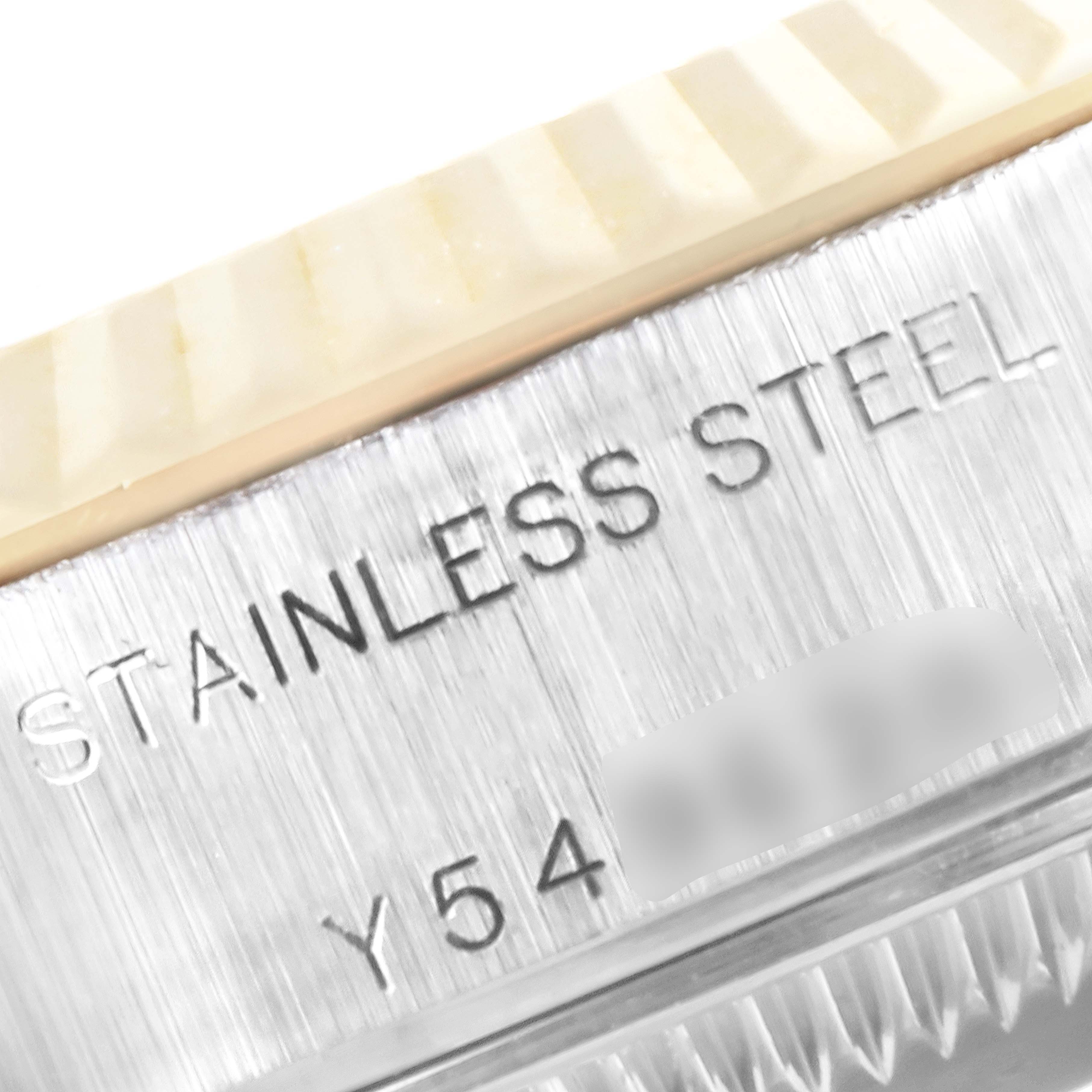 This image shows a close-up of the case side of a Rolex Datejust 79173 Women
s Steel and Gold (two tone) White Dial 79173 Women
s Steel and Gold (two tone) White Dial watch with "STAINLESS STEEL" engraved on it.