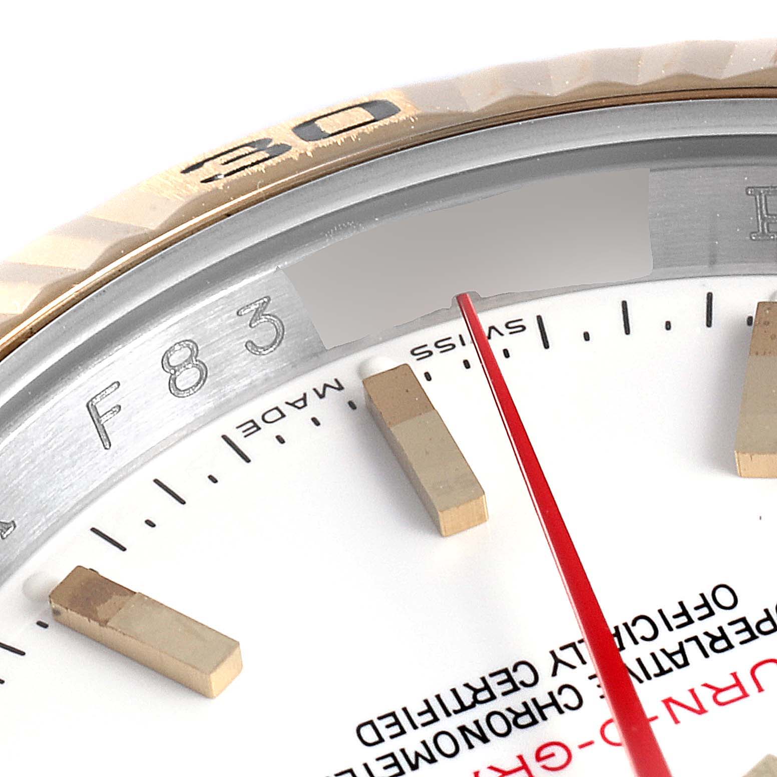 The close-up angle of the Rolex Turn-o-Graph 116263 Men's Steel and Gold (two tone) White Dial 116263 Men's Steel and Gold (two tone) White Dial watch shows a portion of the bezel, dial, and markers.