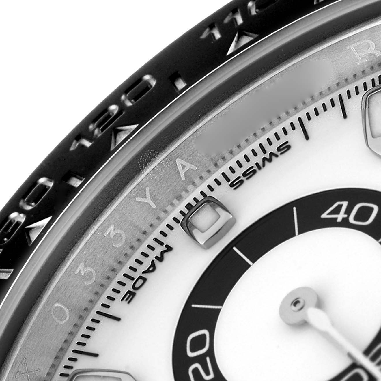The image shows a close-up of the bezel and part of the dial of a Rolex Daytona 116500 Men's Stainless Steel White Dial 116500 Men's Stainless Steel White Dial watch.