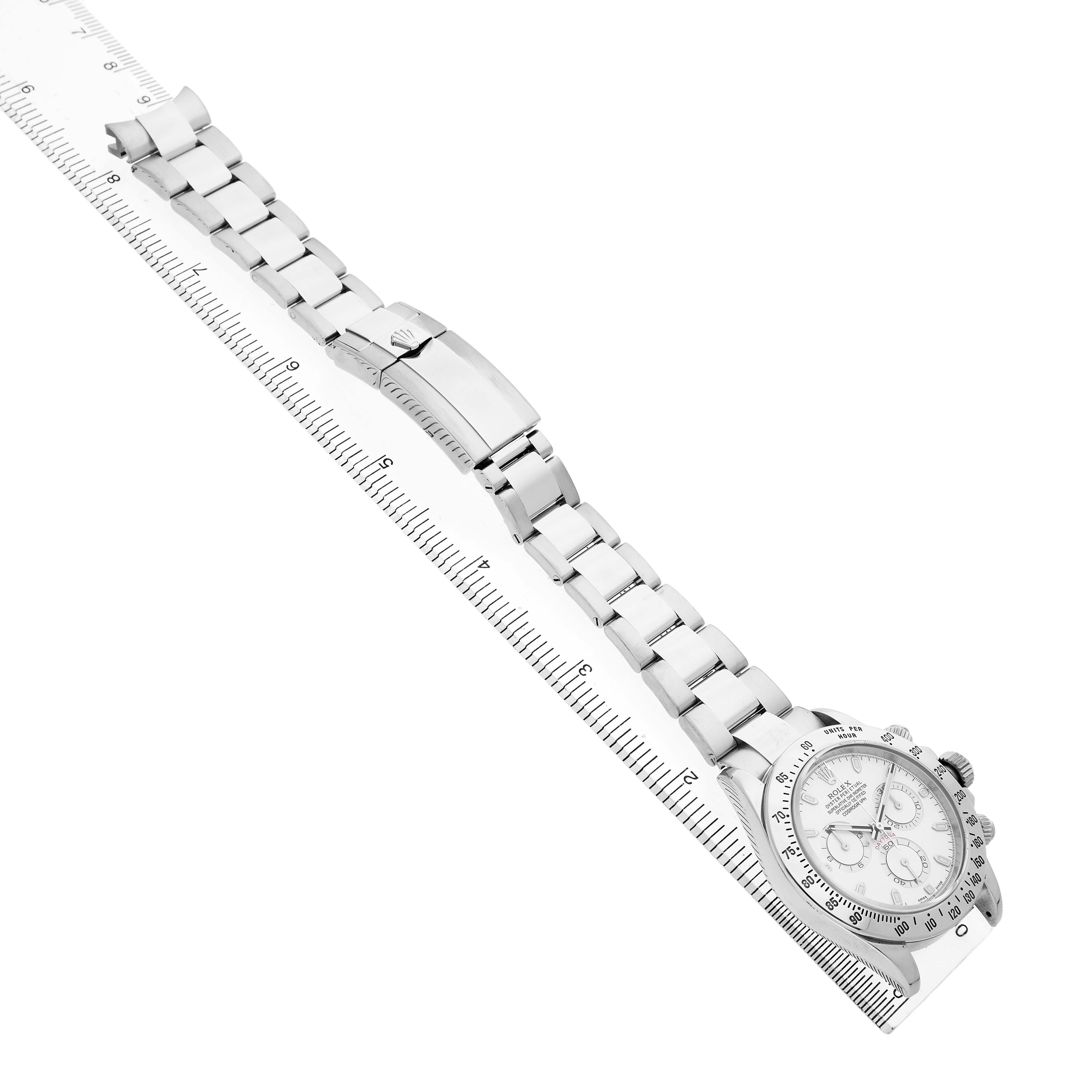 The Rolex Daytona 116520 Men's Stainless Steel White Dial watch is shown at a slight angle, displaying the full bracelet and face, alongside a ruler for scale.