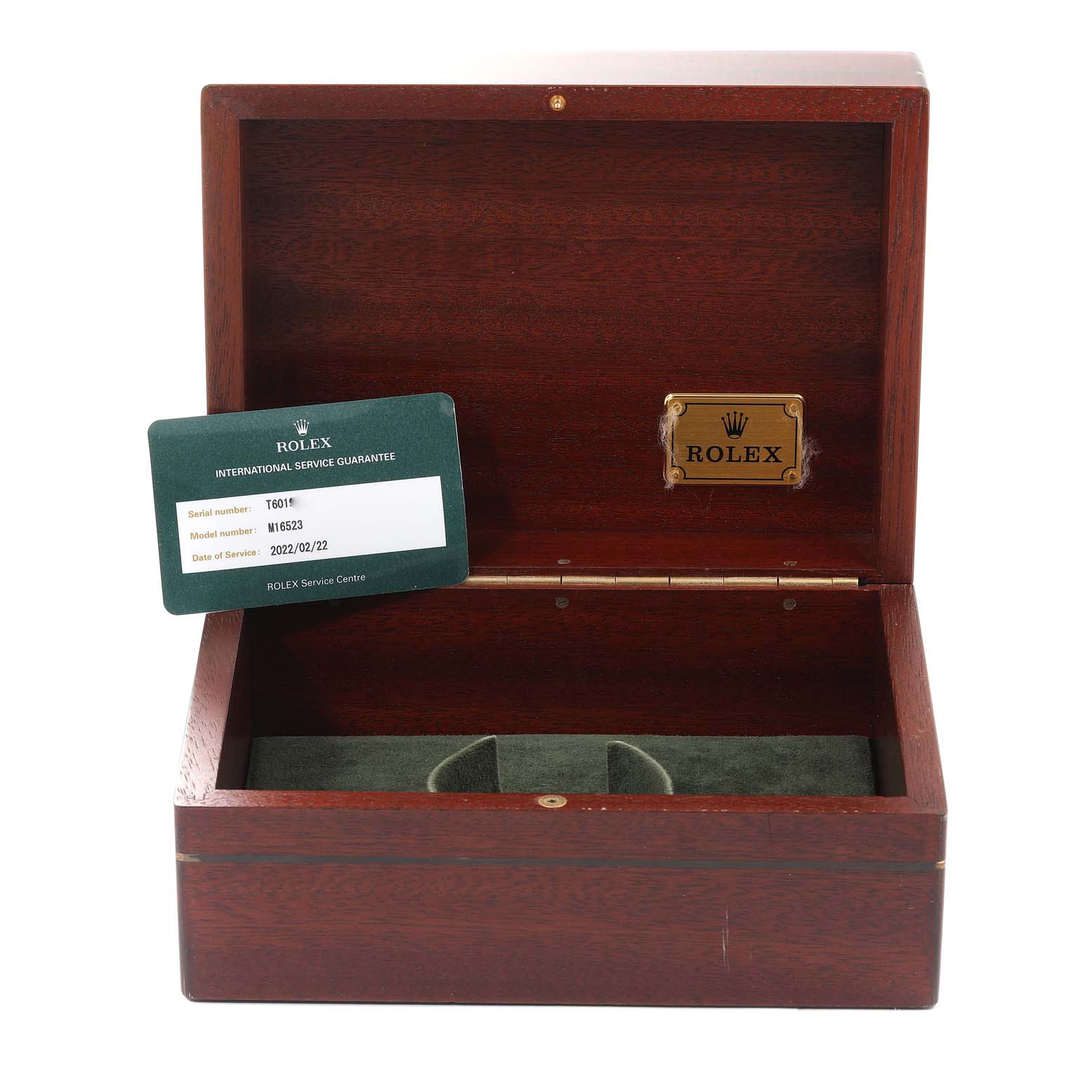 The image shows an open wooden Rolex watch box with a guarantee card, for the Daytona model.