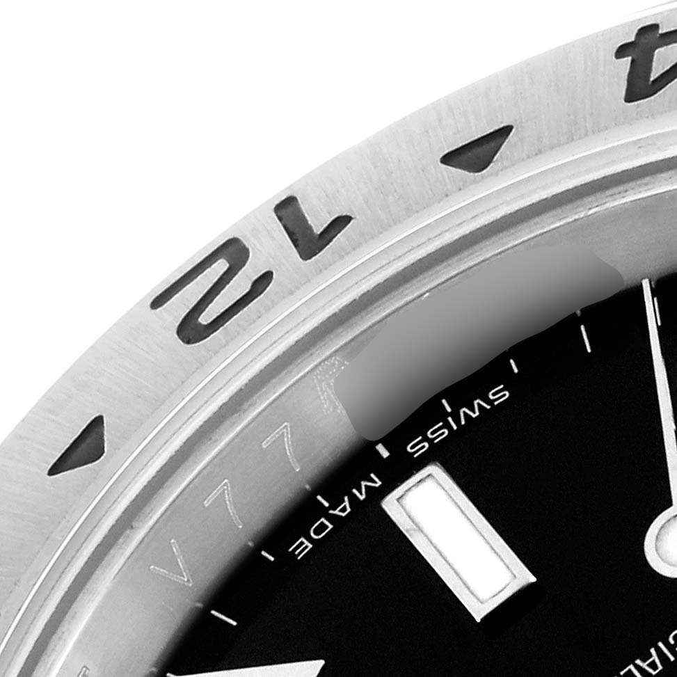 The image shows a close-up of the bezel, dial, and part of the hand of the Rolex Explorer 16570 Men
s Stainless Steel Black Dial 16570 Men
s Stainless Steel Black Dial watch.