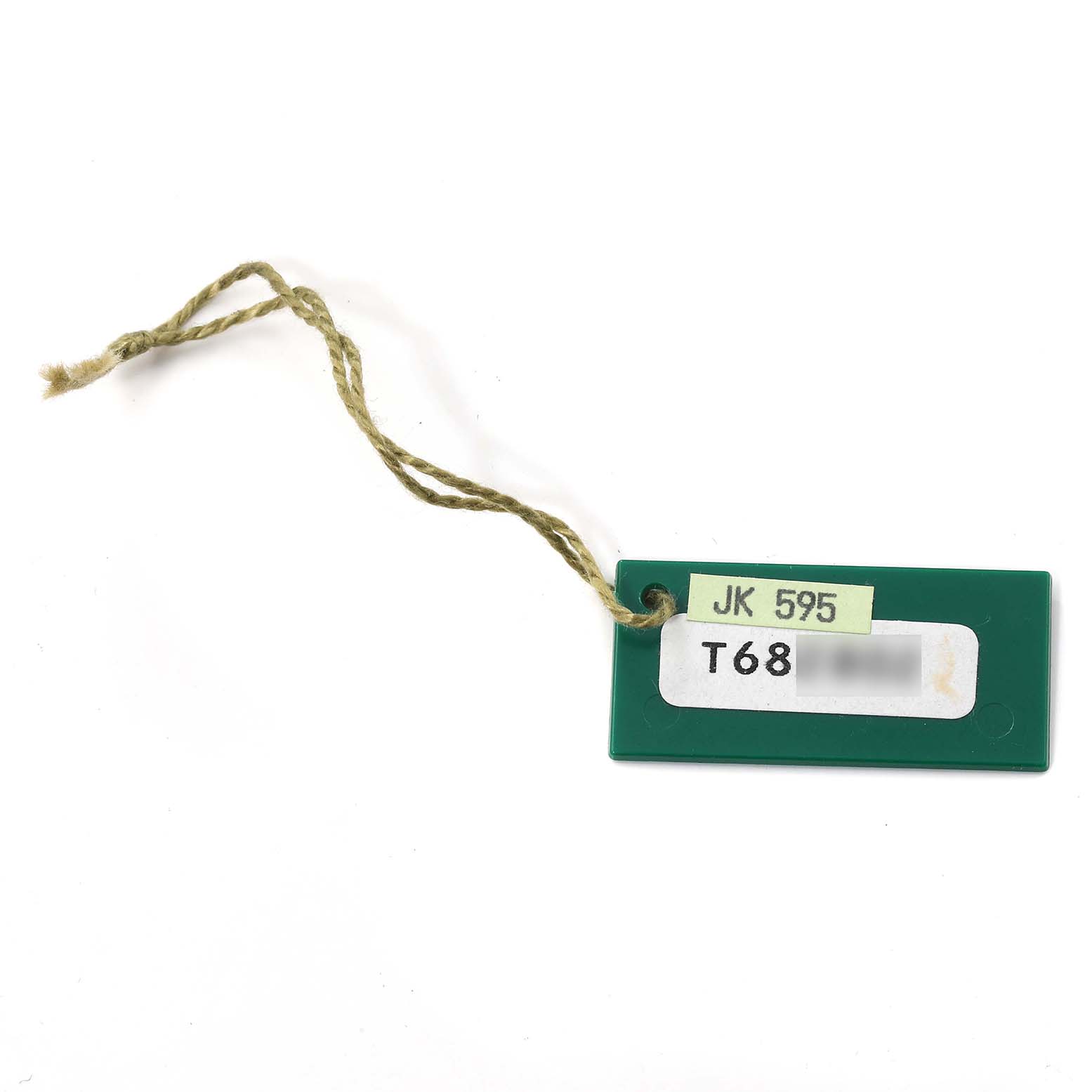 This image shows a green hang tag with a string, an accessory for a Rolex GMT-Master 16710 Men
s Stainless Steel Black Dial 16710 Men
s Stainless Steel Black Dial watch.