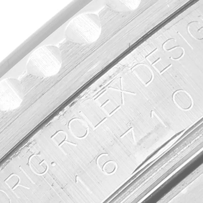 The image shows a close-up of the side of the bezel and case of a Rolex GMT-Master 16710 Men's Stainless Steel Black Dial 16710 Men's Stainless Steel Black Dial watch, highlighting the "ROLEX DESIGN" engraving.