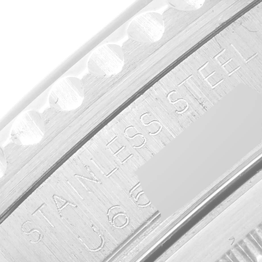 This image shows a close-up of the side of a Rolex GMT-Master 16710 Men's Stainless Steel Black Dial 16710 Men's Stainless Steel Black Dial watch, highlighting its stainless steel markings and part of the bezel.