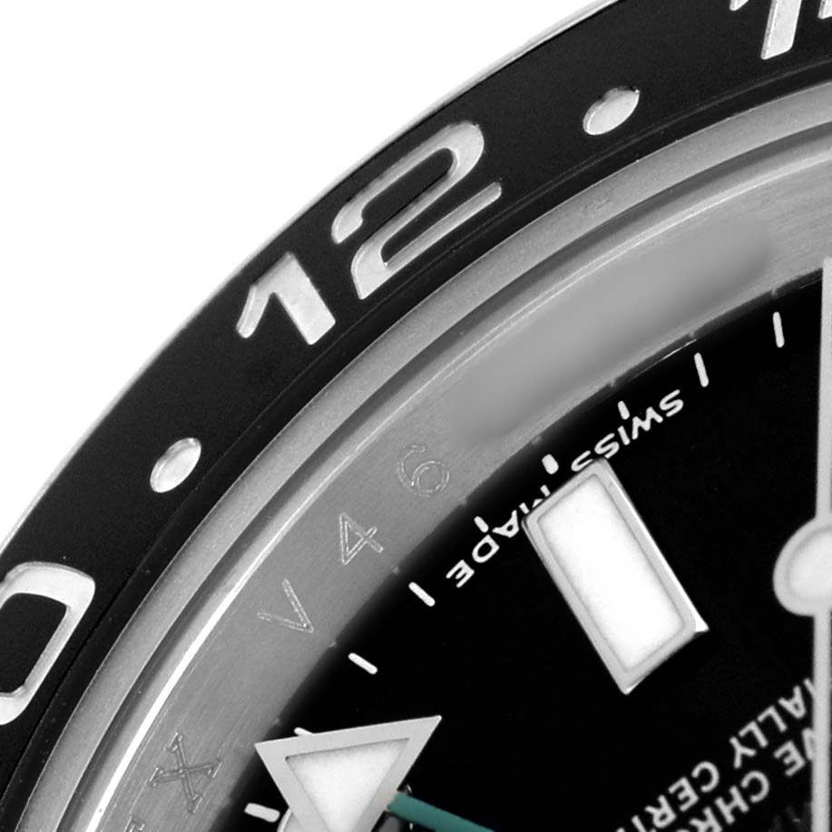 The image shows a close-up of a Rolex GMT-Master 116710 Men's Stainless Steel Black Dial watch, focusing on the bezel, part of the dial, and hour markers.