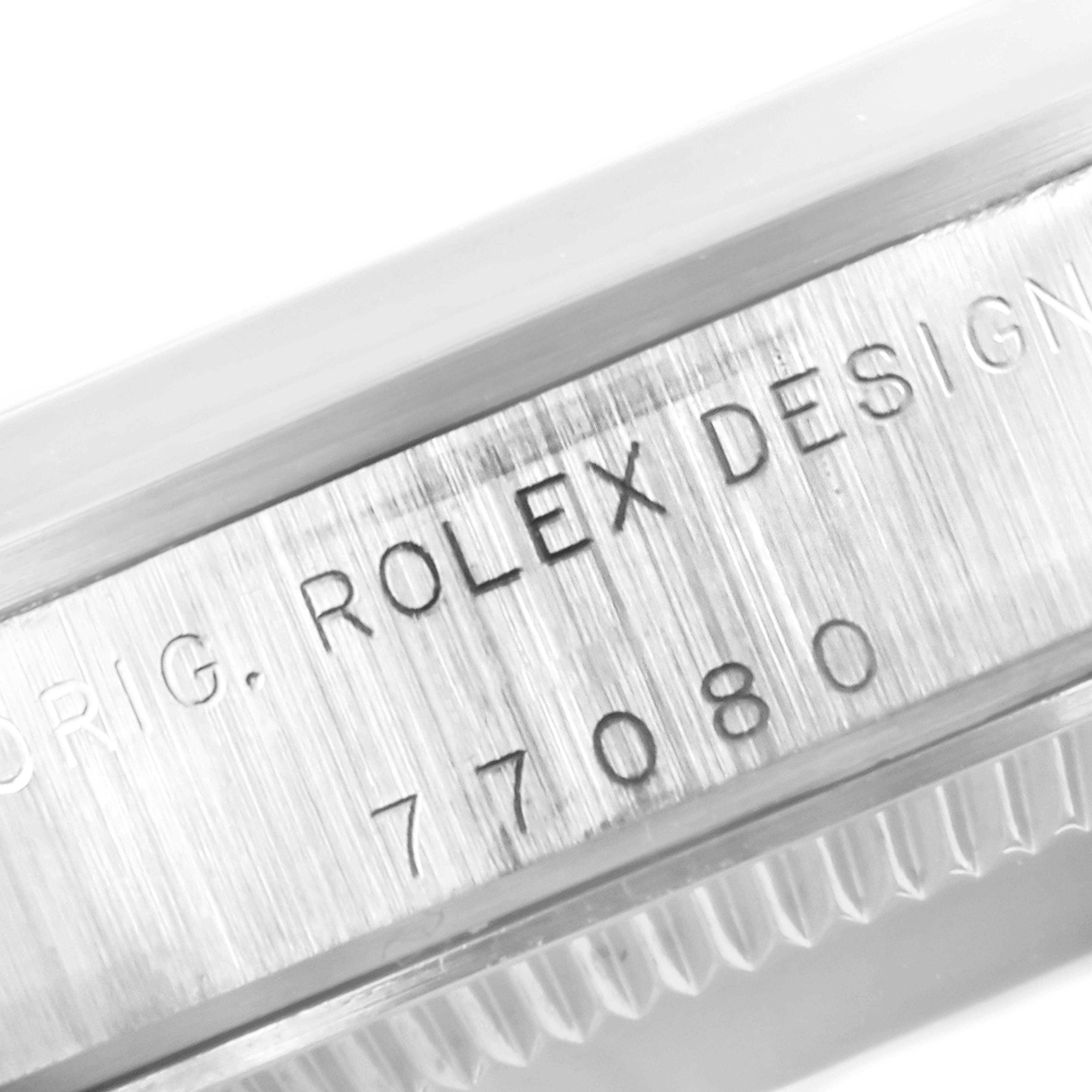 This image shows a close-up view of the side engraving of a Mid-Size Rolex watch, featuring the model number 77080.