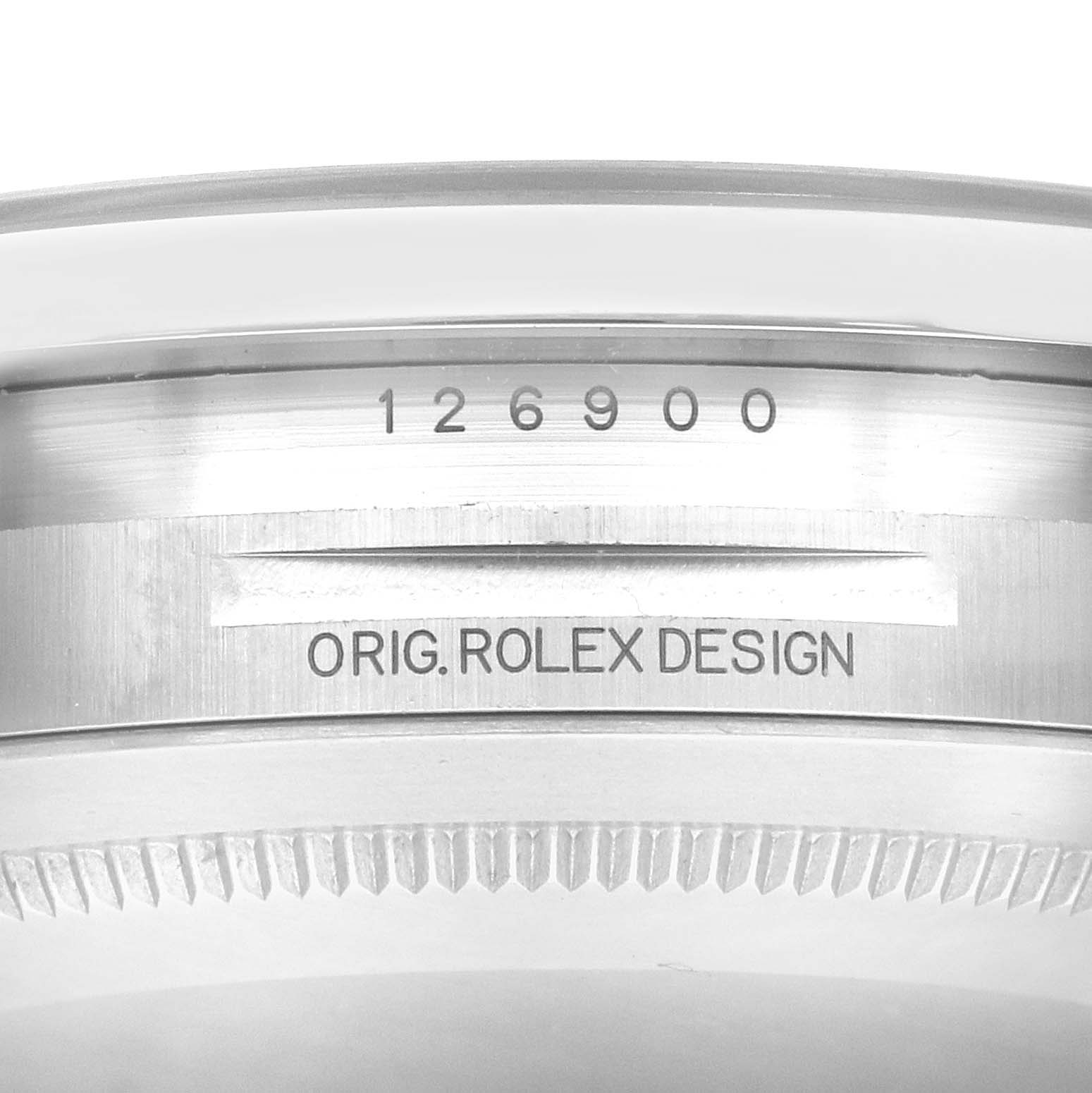 The image shows a close-up of the case engraving on the Rolex Air-King, model 126900, displaying the model number and "ORIG. ROLEX DESIGN."
