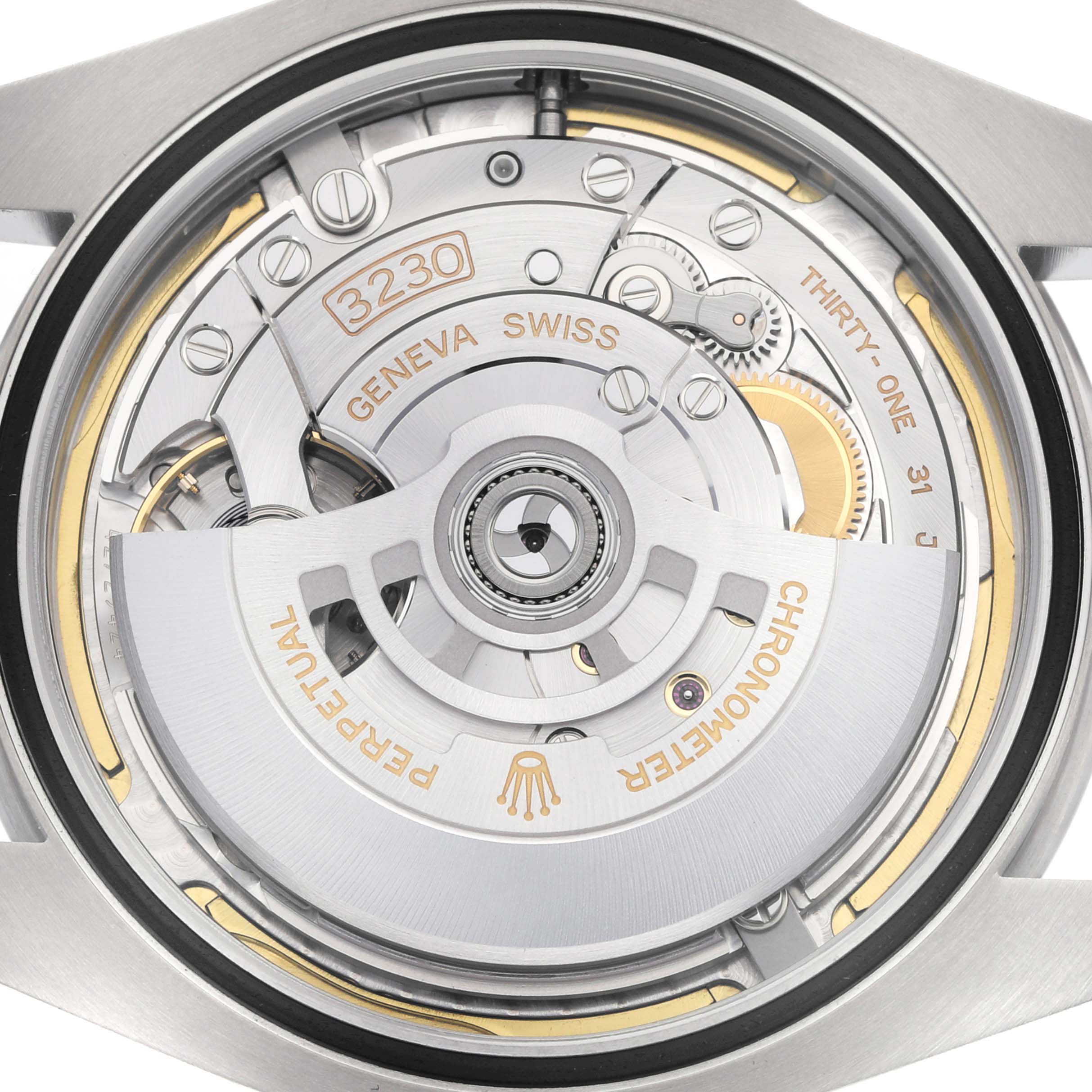 The image shows the back view of a Rolex Air-King model 126900, highlighting its mechanical movement with intricate gears and the "Perpetual" rotor.