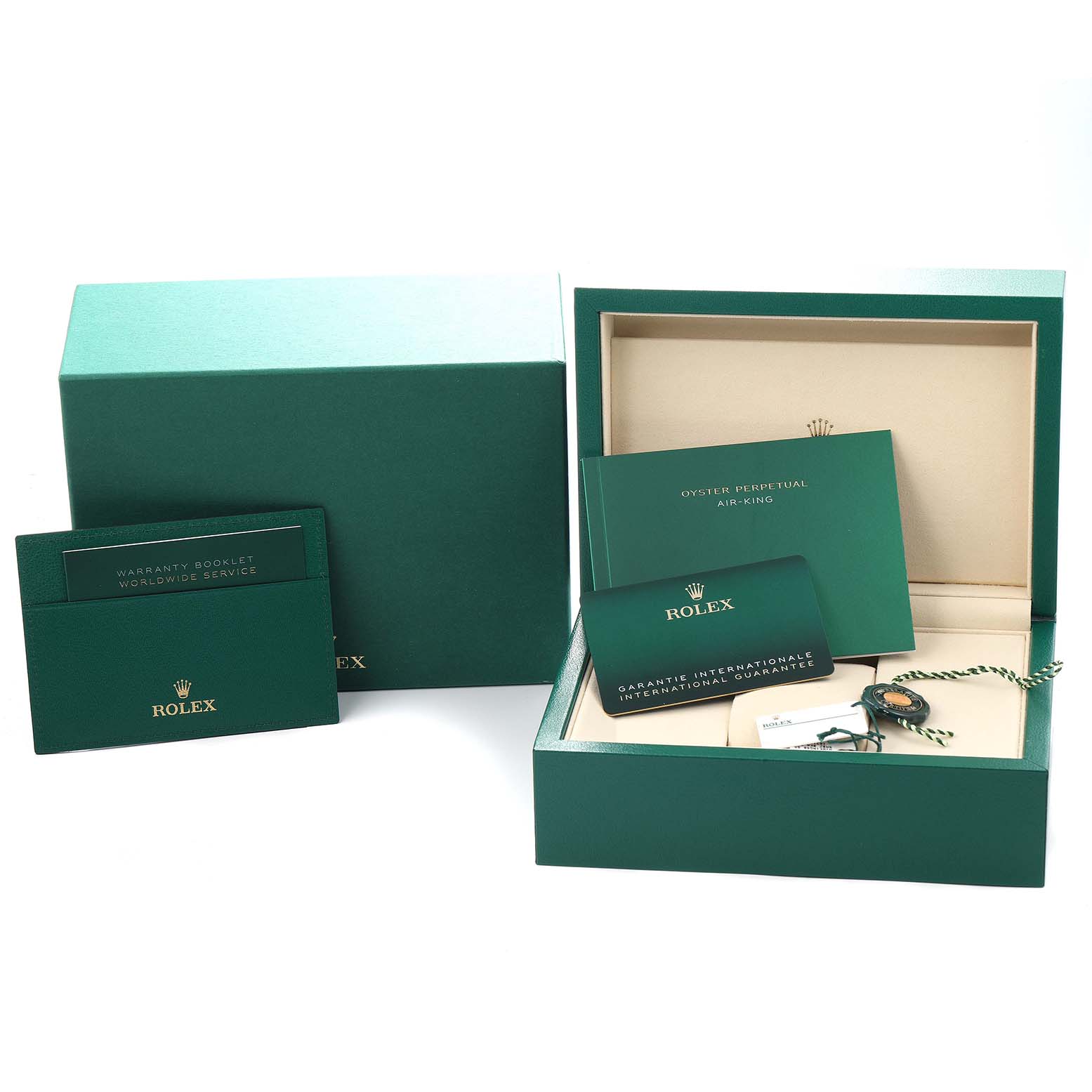 The image shows the packaging and accessories for a Rolex Air-King model 126900, including the box, warranty booklet, and tags, viewed from a frontal angle.