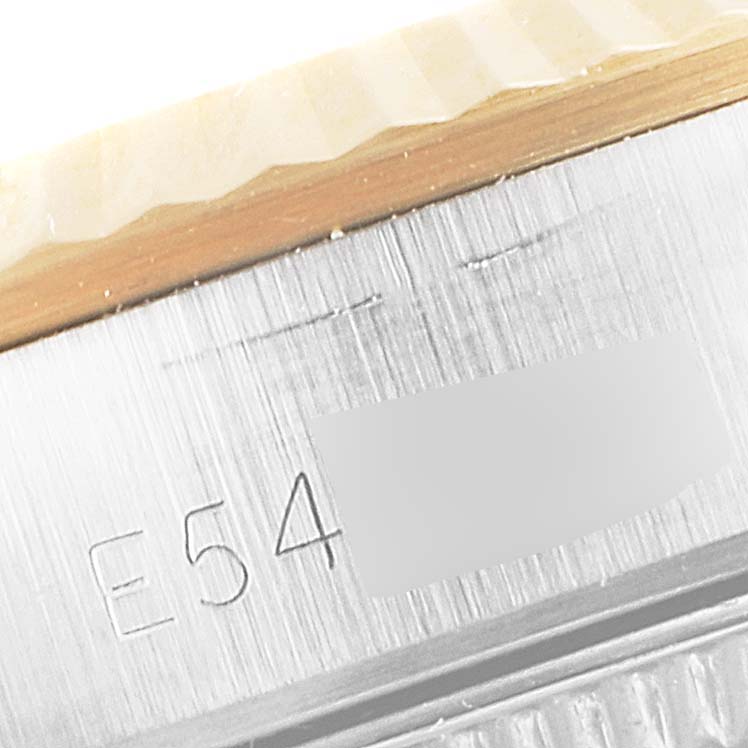 This close-up angle shows the engraved serial number and part of the bezel of the Rolex Oyster Perpetual 67193 Women
s Steel and Gold (two tone) Champagne Dial 67193 Women
s Steel and Gold (two tone) Champagne Dial watch.