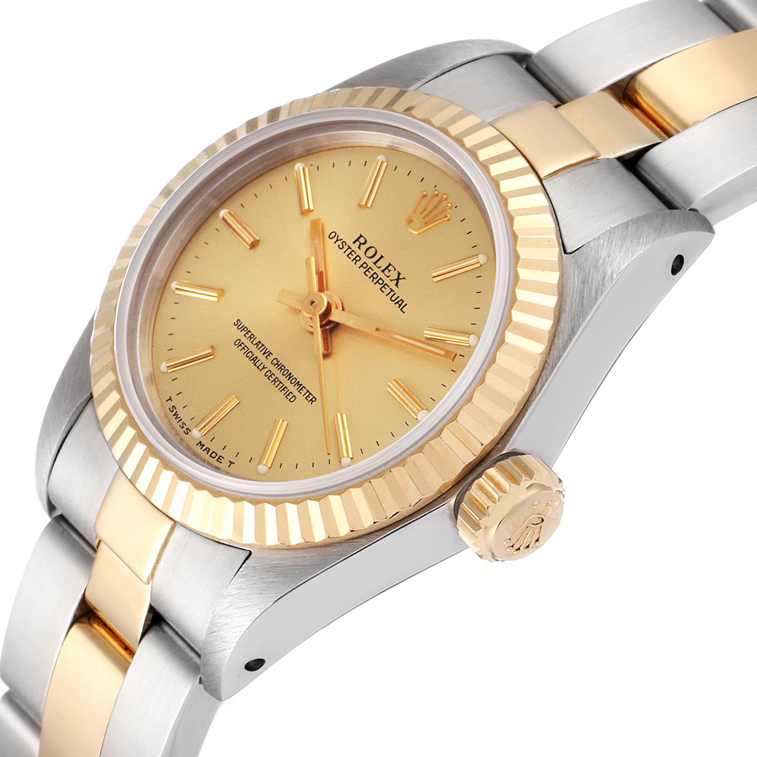 The image shows a side angle of a Rolex Oyster Perpetual 67193 Women
s Steel and Gold (two tone) Champagne Dial 67193 Women
s Steel and Gold (two tone) Champagne Dial watch, highlighting its bezel, crown, dial, and part of the bracelet.