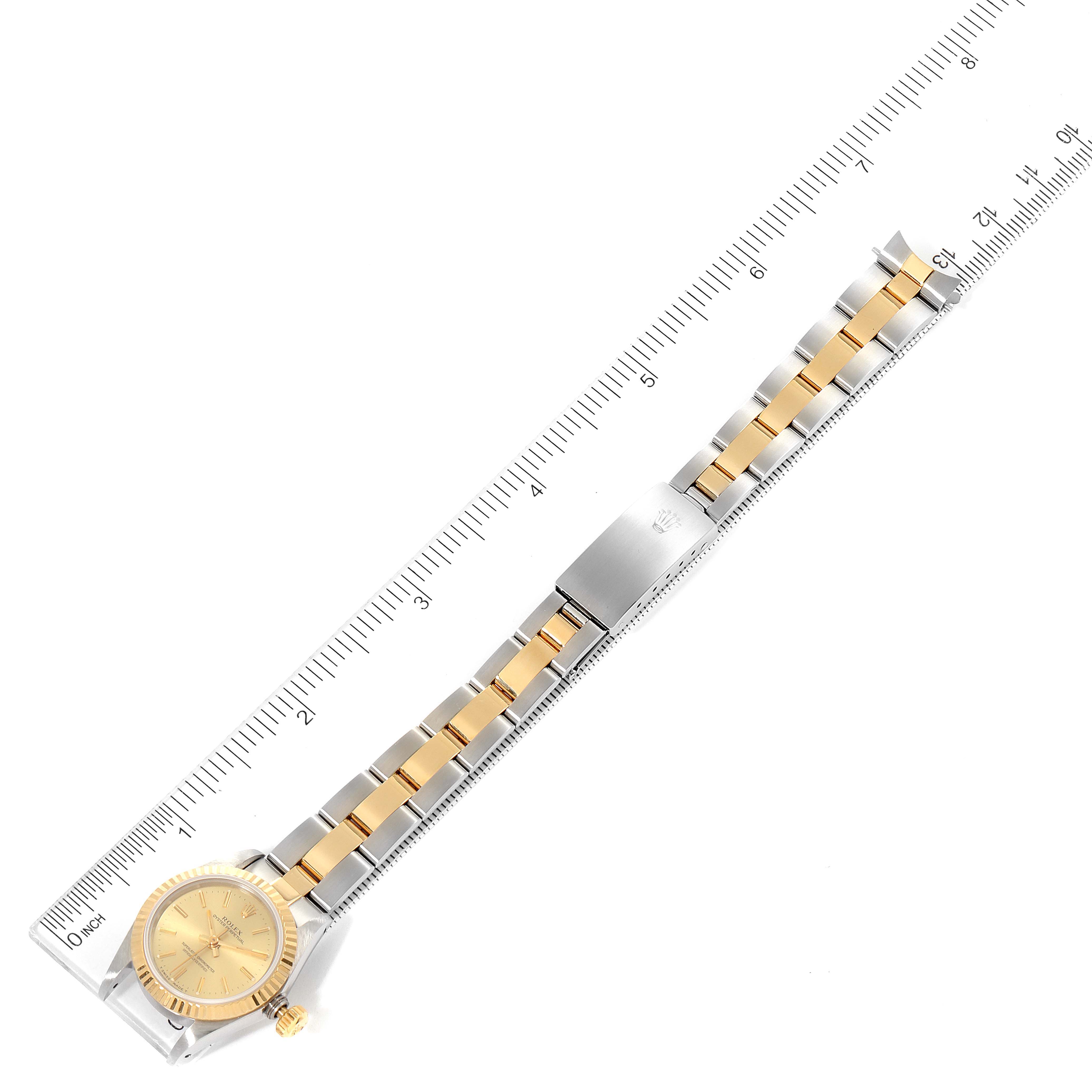 This is a top-down view of a Rolex Oyster Perpetual 67193 Women
s Steel and Gold (two tone) Champagne Dial 67193 Women
s Steel and Gold (two tone) Champagne Dial watch, highlighting the full bracelet, clasp, and face.