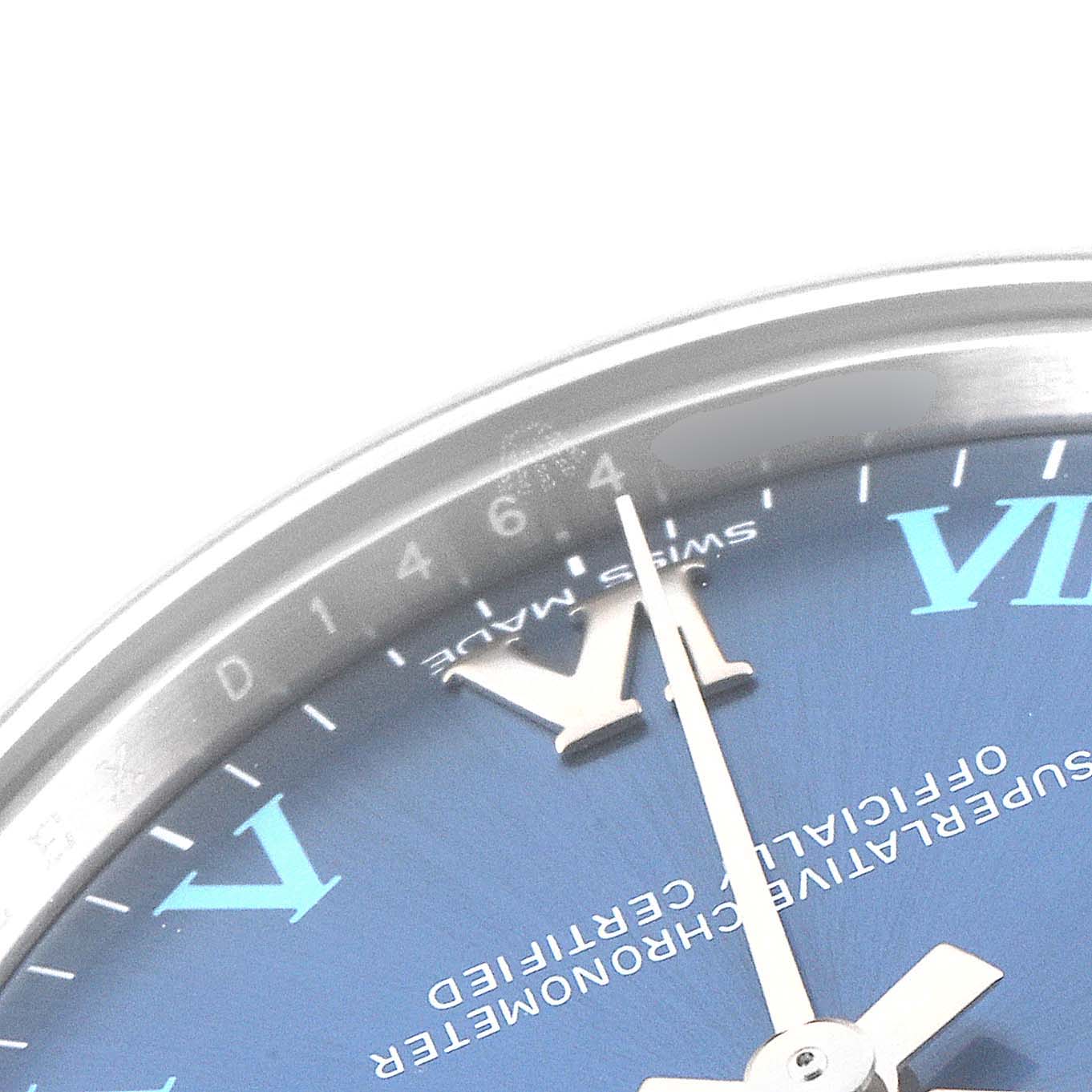 This close-up image of a Rolex Oyster Perpetual 177200 Men
s Stainless Steel Blue Dial 177200 Men
s Stainless Steel Blue Dial watch shows a portion of the blue dial, Roman numeral markers, and the minute hand.