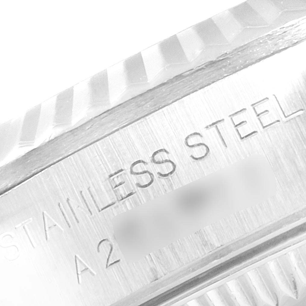 This close-up image shows the stainless steel case and part of the bezel of a Rolex Oyster Perpetual 76094 Women
s Stainless Steel Black Dial 76094 Women
s Stainless Steel Black Dial watch.