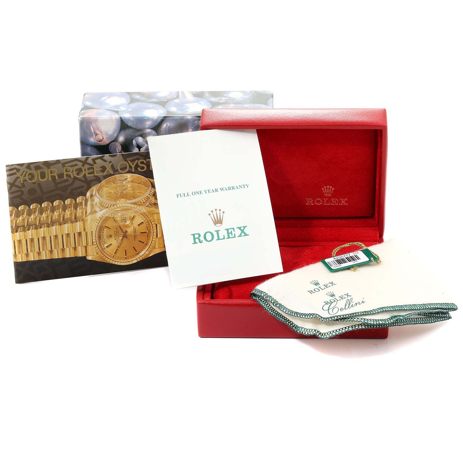 This image shows the packaging accessories, including the box, warranty card, and pamphlet, for a Rolex Oyster Perpetual 76094 Women
s Stainless Steel Black Dial 76094 Women
s Stainless Steel Black Dial watch.