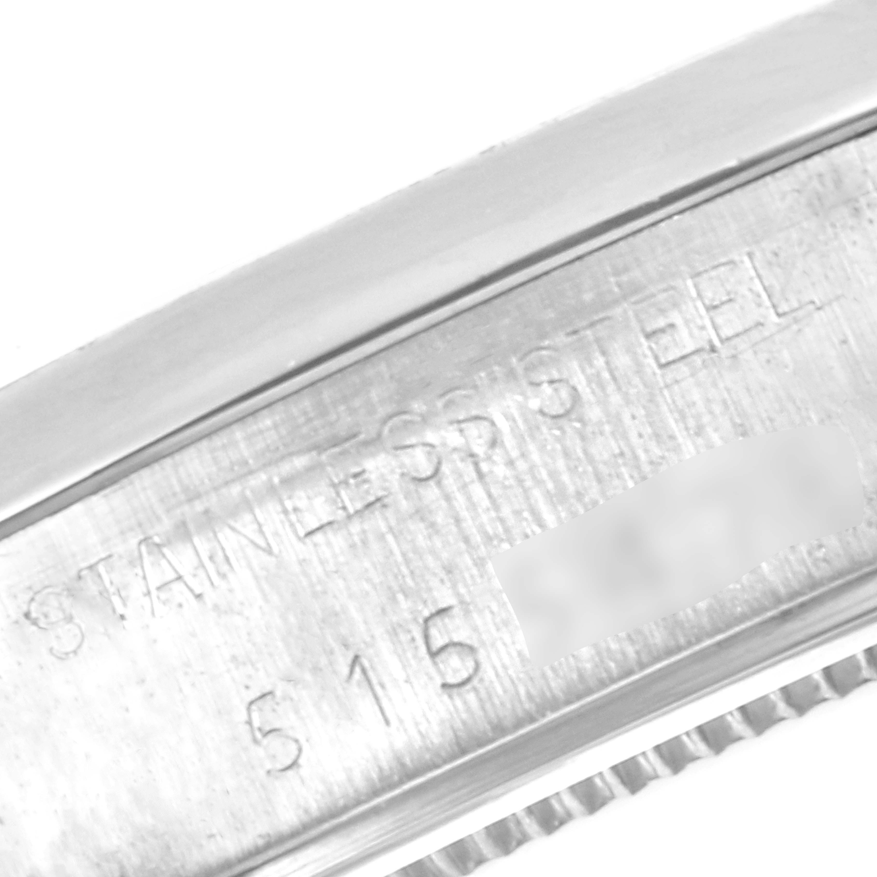 This image shows a close-up of the side of the case back of a Rolex Vintage Collection 6694 Men's Stainless Steel Silver Dial 6694 Men's Stainless Steel Silver Dial model, highlighting the engraving "STAINLESS STEEL" and a partial serial number.