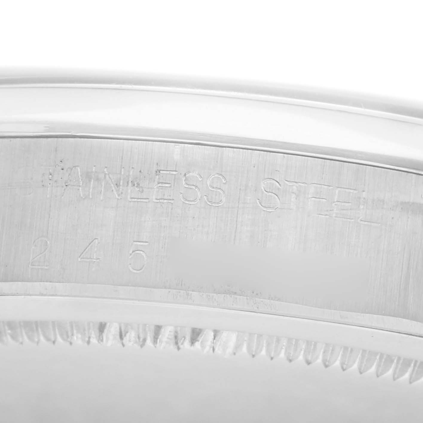 The image shows a close-up of the side of a Rolex Vintage Collection model 6694 men
s watch, highlighting the "STAINLESS STEEL" engraving.