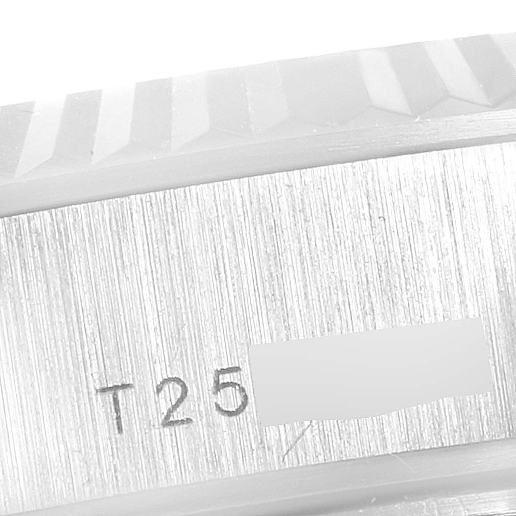 This close-up image shows the fluted bezel and serial number of a Rolex President 69179 Women's White Gold Silver Dial 69179 Women's White Gold Silver Dial model watch.