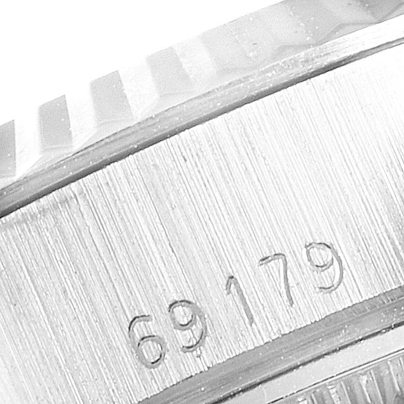 This close-up angle shows the side of the Rolex President 69179 Women's White Gold Silver Dial 69179 Women's White Gold Silver Dial model, focusing on the serial number engraving and part of the bezel.