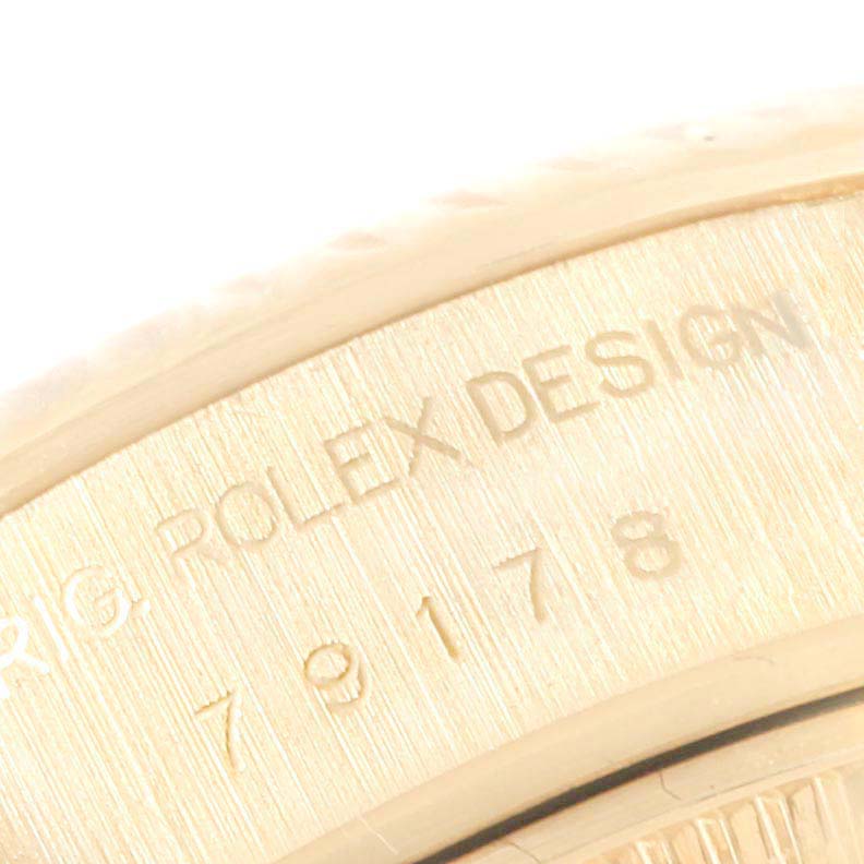 The image shows a close-up of the side of a Rolex President 79178 Women
s Yellow Gold Champagne Dial 79178 Women
s Yellow Gold Champagne Dial model, highlighting the engraved serial and model numbers.