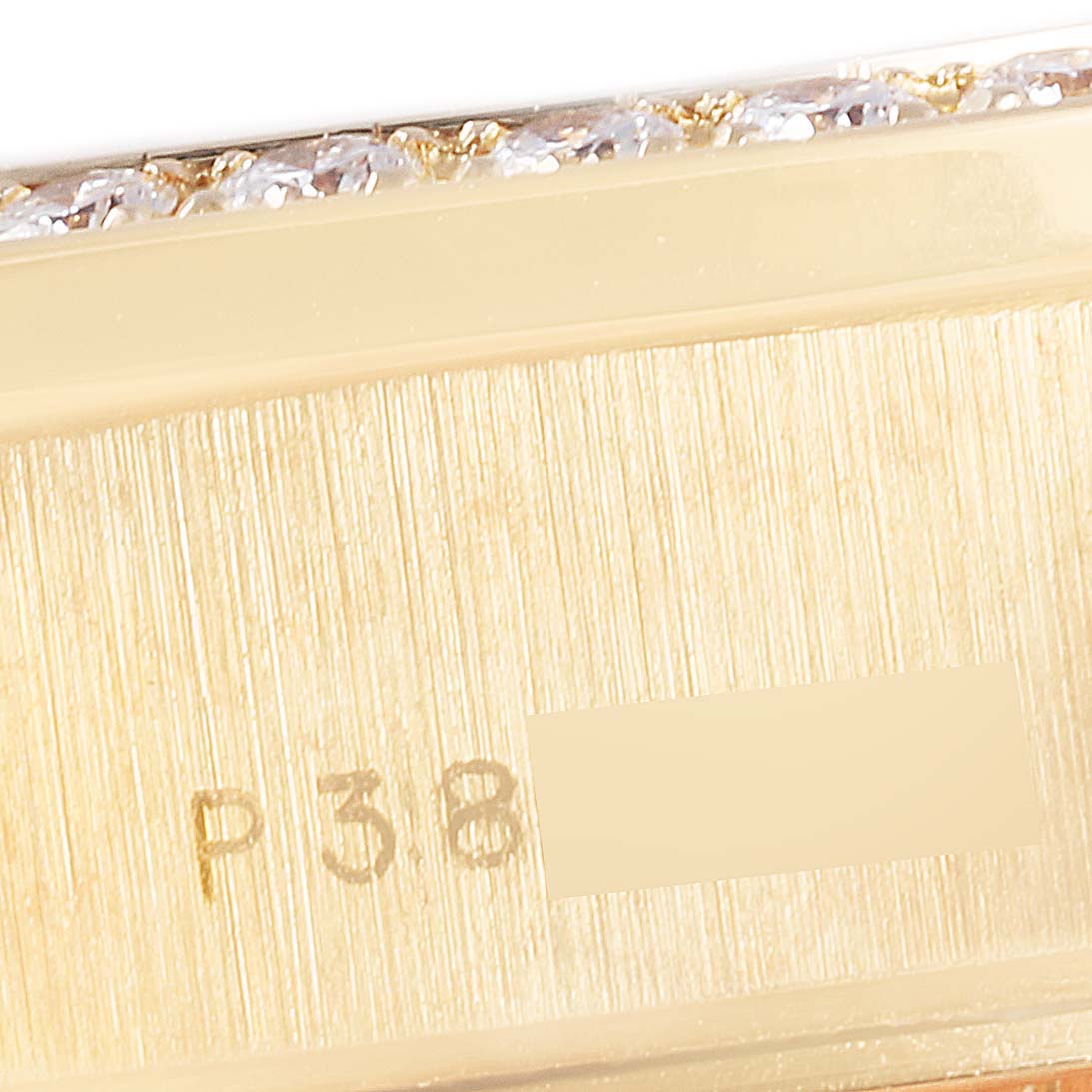 The image shows a close-up of the side of a Rolex President 79178 Women
s Yellow Gold Champagne Dial 79178 Women
s Yellow Gold Champagne Dial model, highlighting its serial number and diamonds on the bezel.