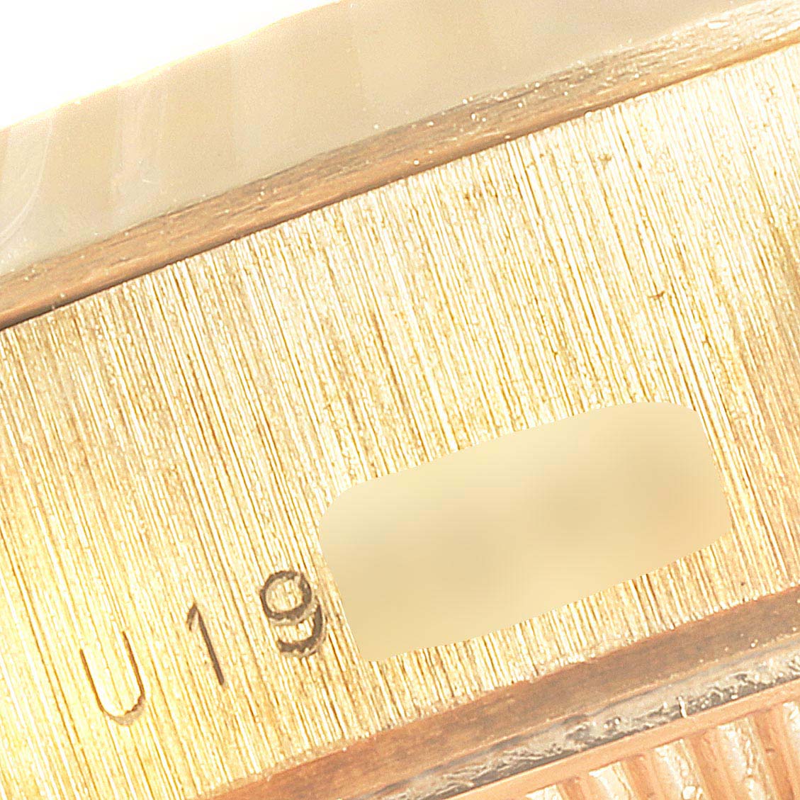 This image shows a close-up of the case side, with visible serial number detailing, of a Rolex President 79178 Women
s Yellow Gold Champagne Dial 79178 Women
s Yellow Gold Champagne Dial model watch.