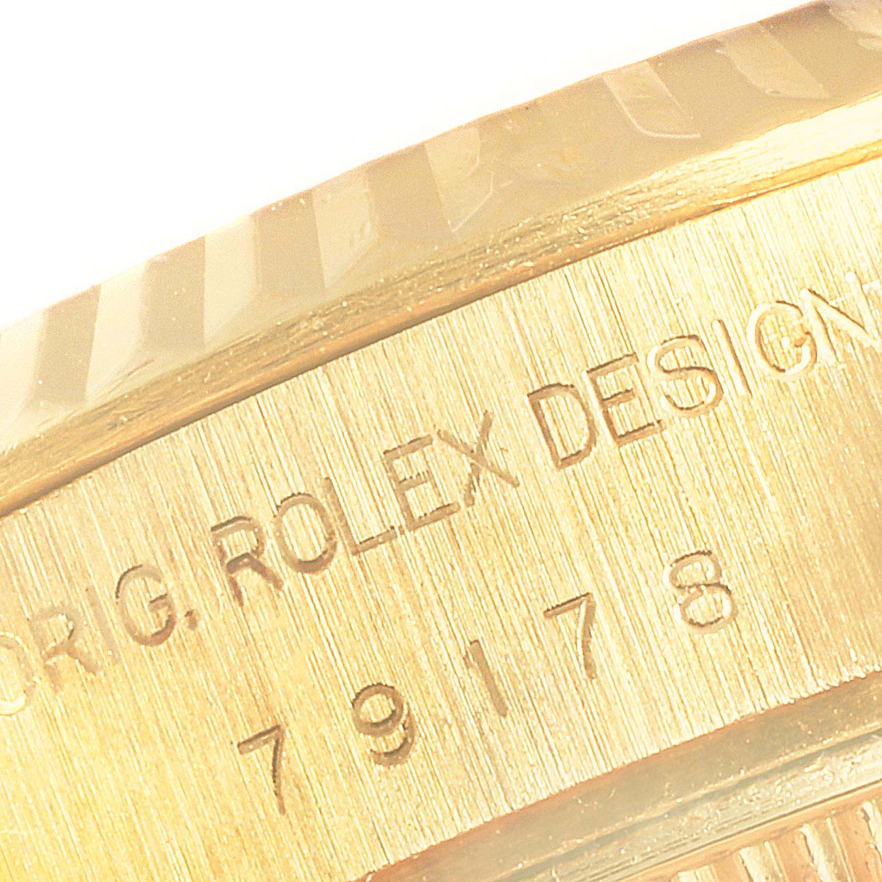 This close-up image shows the side engraving and bezel detail of a Rolex President 79178 Women
s Yellow Gold Champagne Dial 79178 Women
s Yellow Gold Champagne Dial model watch.