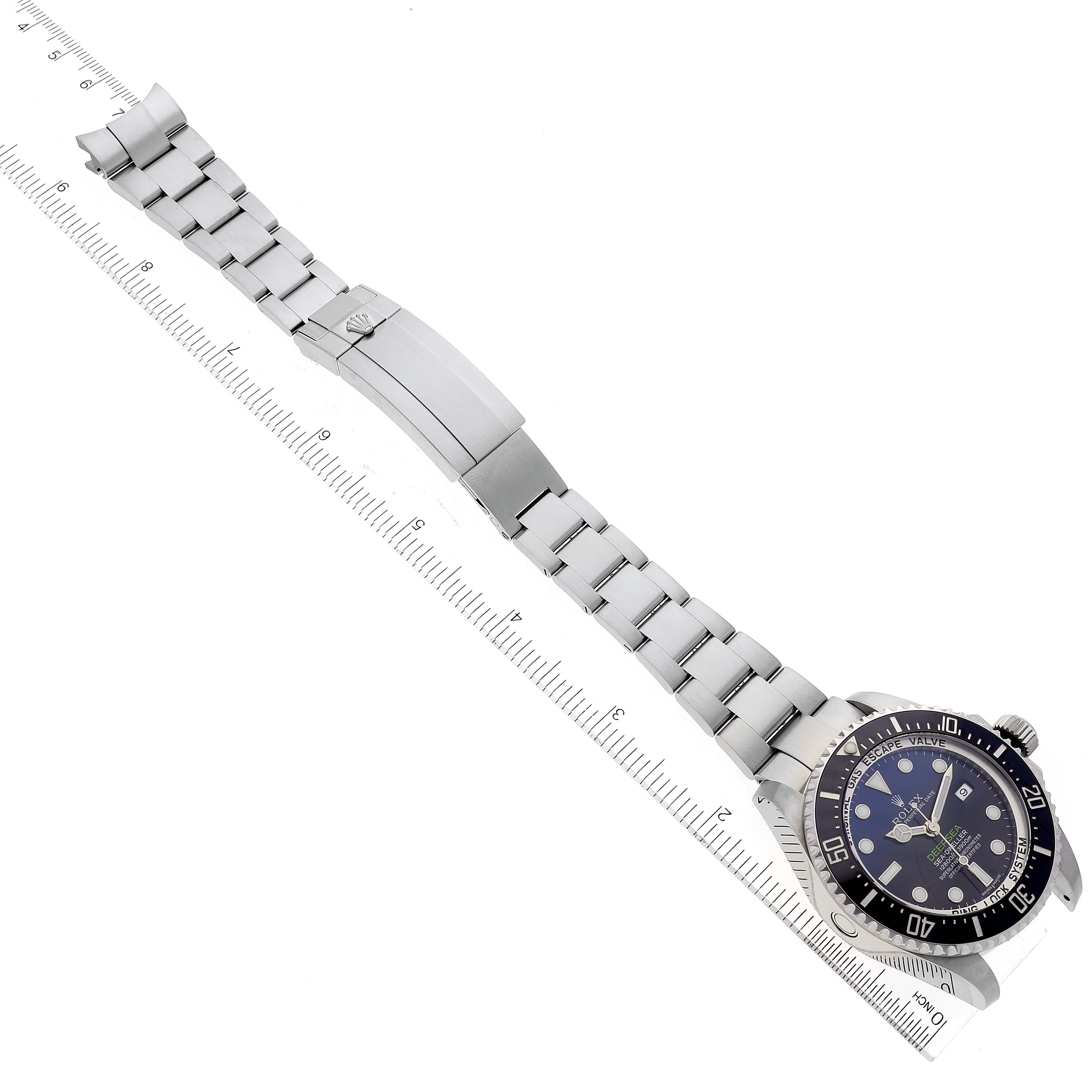 The image shows the Rolex Sea-Dweller 116660 Men
s Stainless Steel Blue Dial 116660 Men
s Stainless Steel Blue Dial watch laid flat with the bracelet extended and a ruler placed next to it for scale.