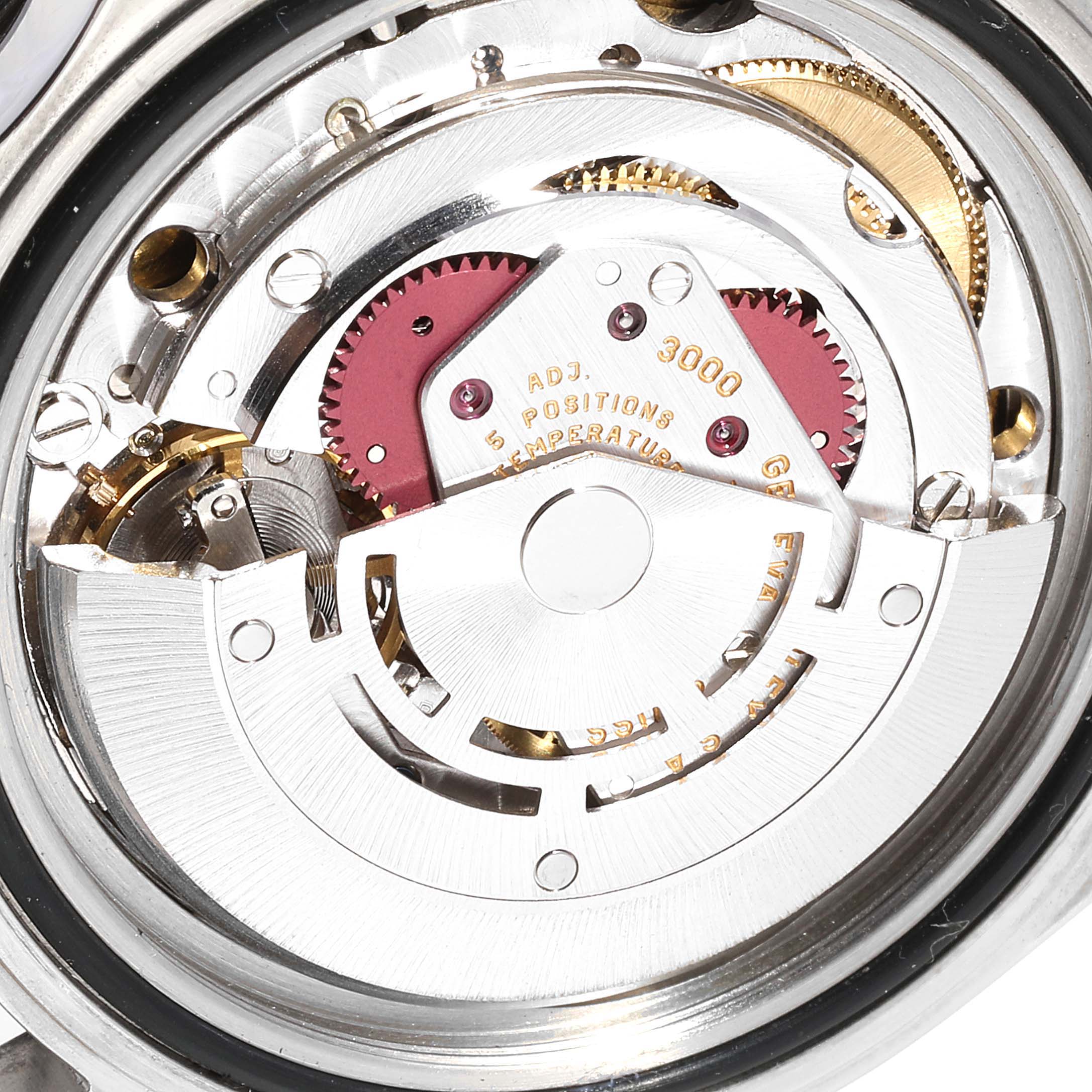 The image shows a close-up view of the movement inside a Rolex Submariner 14060M Men
s Stainless Steel Black Dial 14060M Men
s Stainless Steel Black Dial model watch, showcasing its detailed internal components.