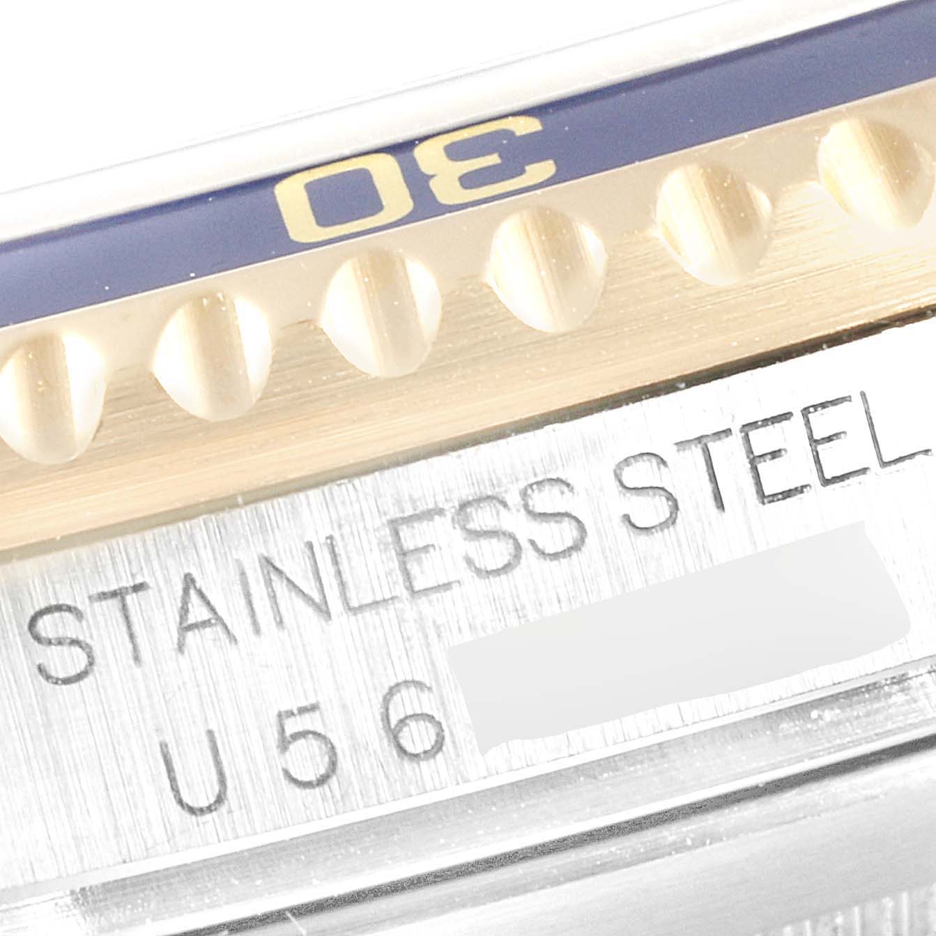 This close-up image shows the bezel and case marking "STAINLESS STEEL" of a Rolex Submariner 16613 Men
s Steel and Gold (two tone) Blue Dial 16613 Men
s Steel and Gold (two tone) Blue Dial watch.