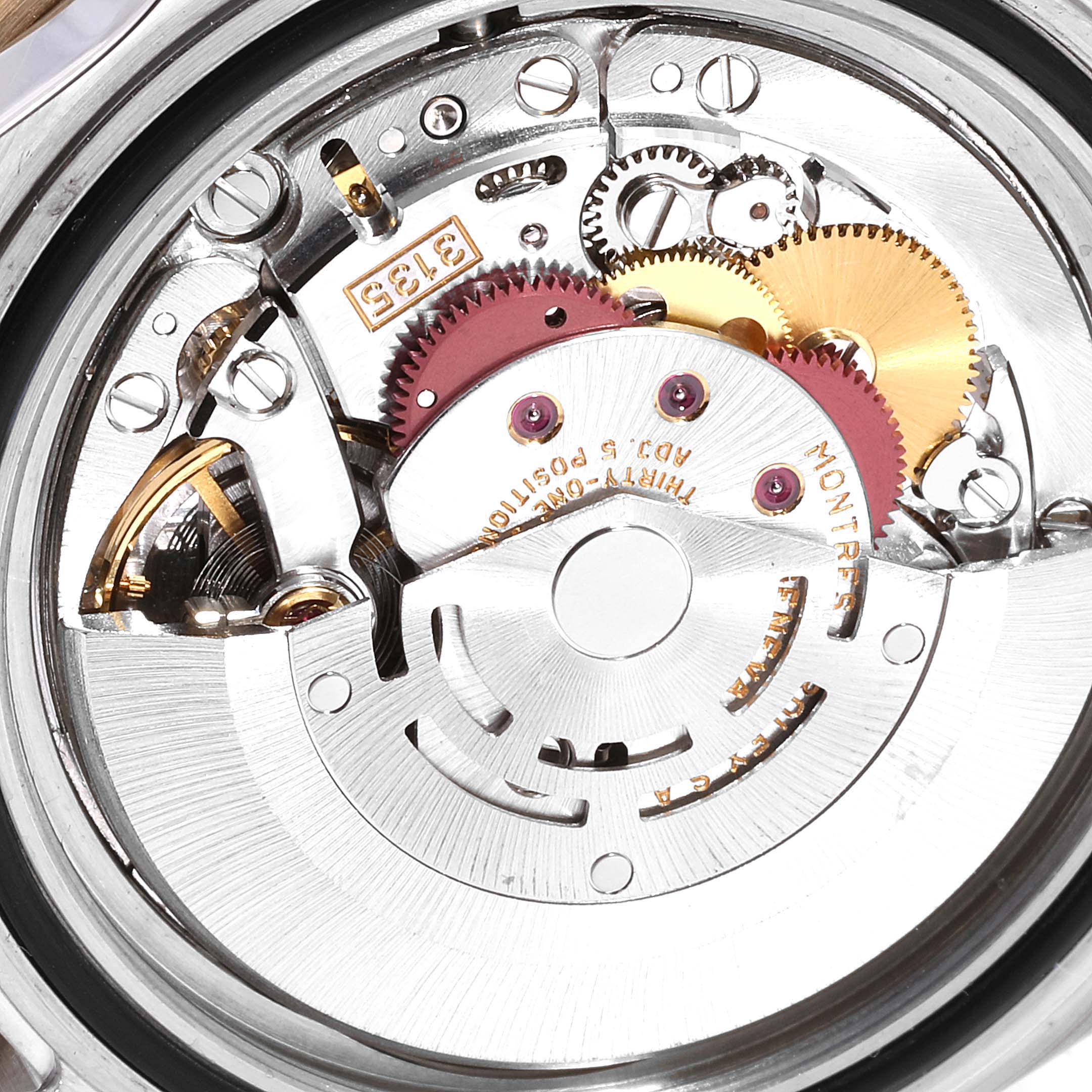 This image shows the intricate internal mechanics of a Rolex Submariner 16613 Men
s Steel and Gold (two tone) Blue Dial 16613 Men
s Steel and Gold (two tone) Blue Dial watch movement from a close-up angle.