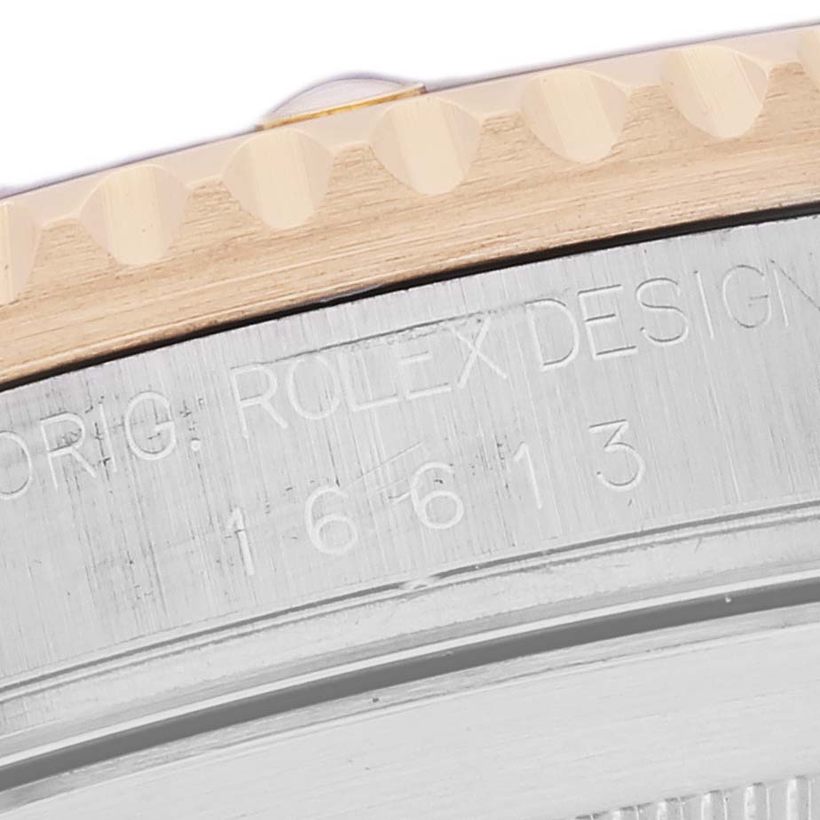 The image shows a close-up of the bezel and edge of the case back on a Rolex Submariner 16613 Men's Steel and Gold (two tone) Blue Dial 16613 Men's Steel and Gold (two tone) Blue Dial model watch.