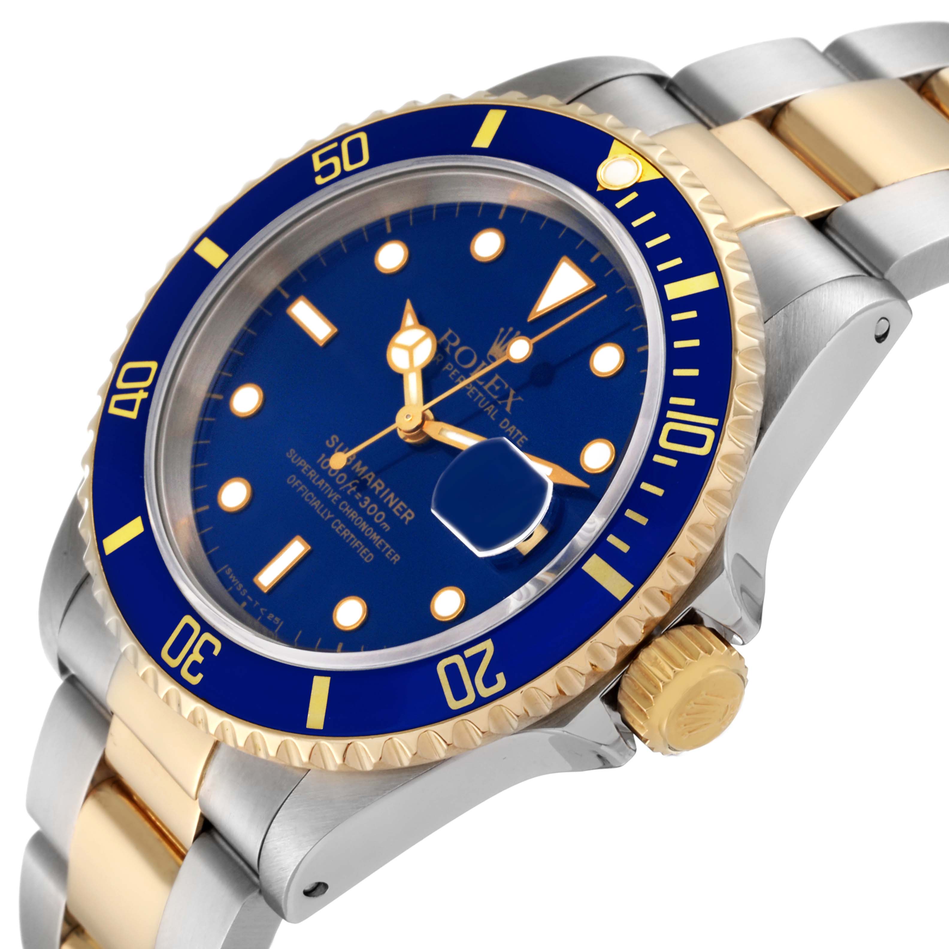The image shows a Rolex Submariner 16613 Men's Steel and Gold (two tone) Blue Dial 16613 Men's Steel and Gold (two tone) Blue Dial at an angled view, highlighting its blue dial, date magnifier, and two-tone bracelet.