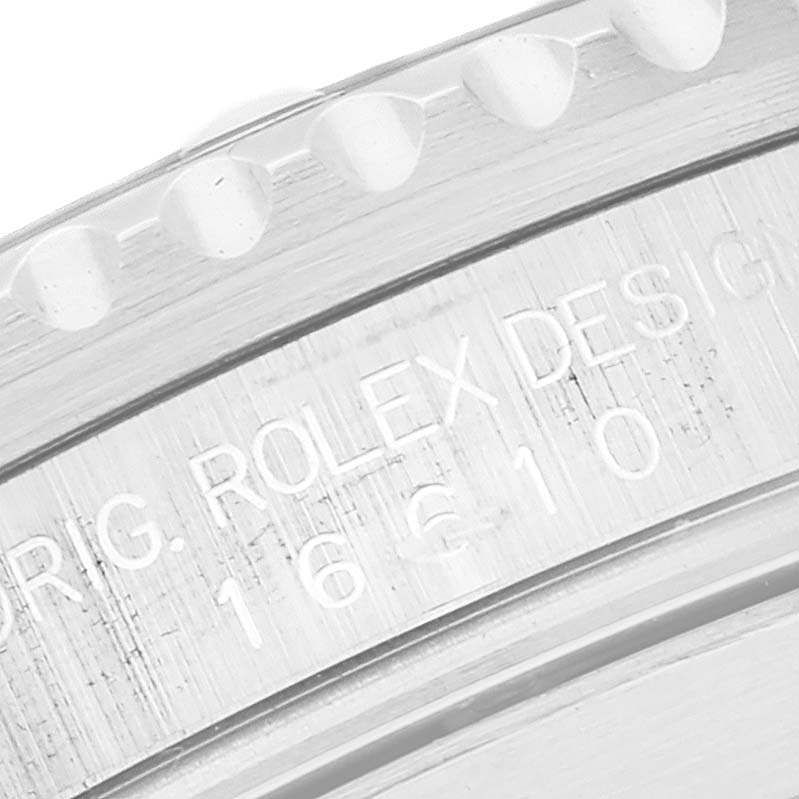 This image shows a close-up of the engraved bezel and inner ring of a Rolex Submariner 16610 Men
s Stainless Steel Black Dial 16610 Men
s Stainless Steel Black Dial watch.