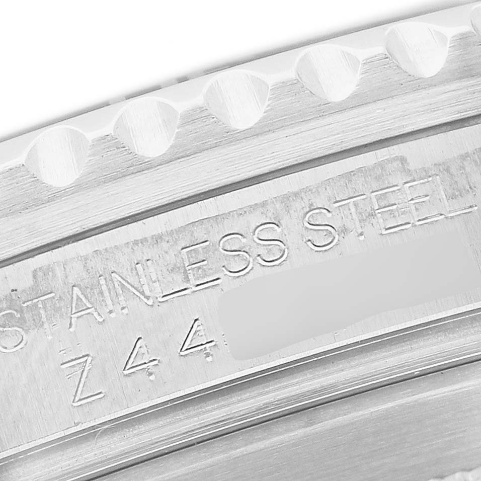The image shows a close-up of the Rolex Submariner 16610 Men's Stainless Steel Black Dial watch's stainless steel bezel with engraved markings.