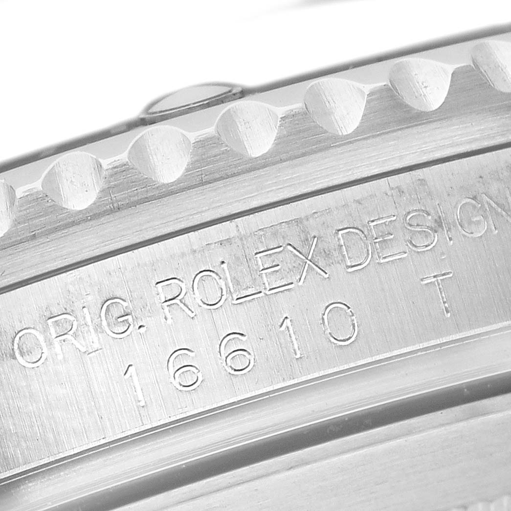 The image shows a close-up of the case side and bezel edge of a Rolex Submariner 16610 Men's Stainless Steel Black Dial, featuring model number engravings.