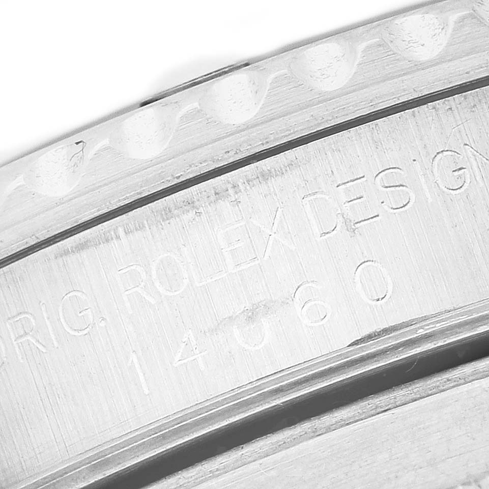 The image shows a close-up of the engraved case back of a Rolex Submariner 14060 Men's Stainless Steel Black Dial, highlighting the branding and model number.